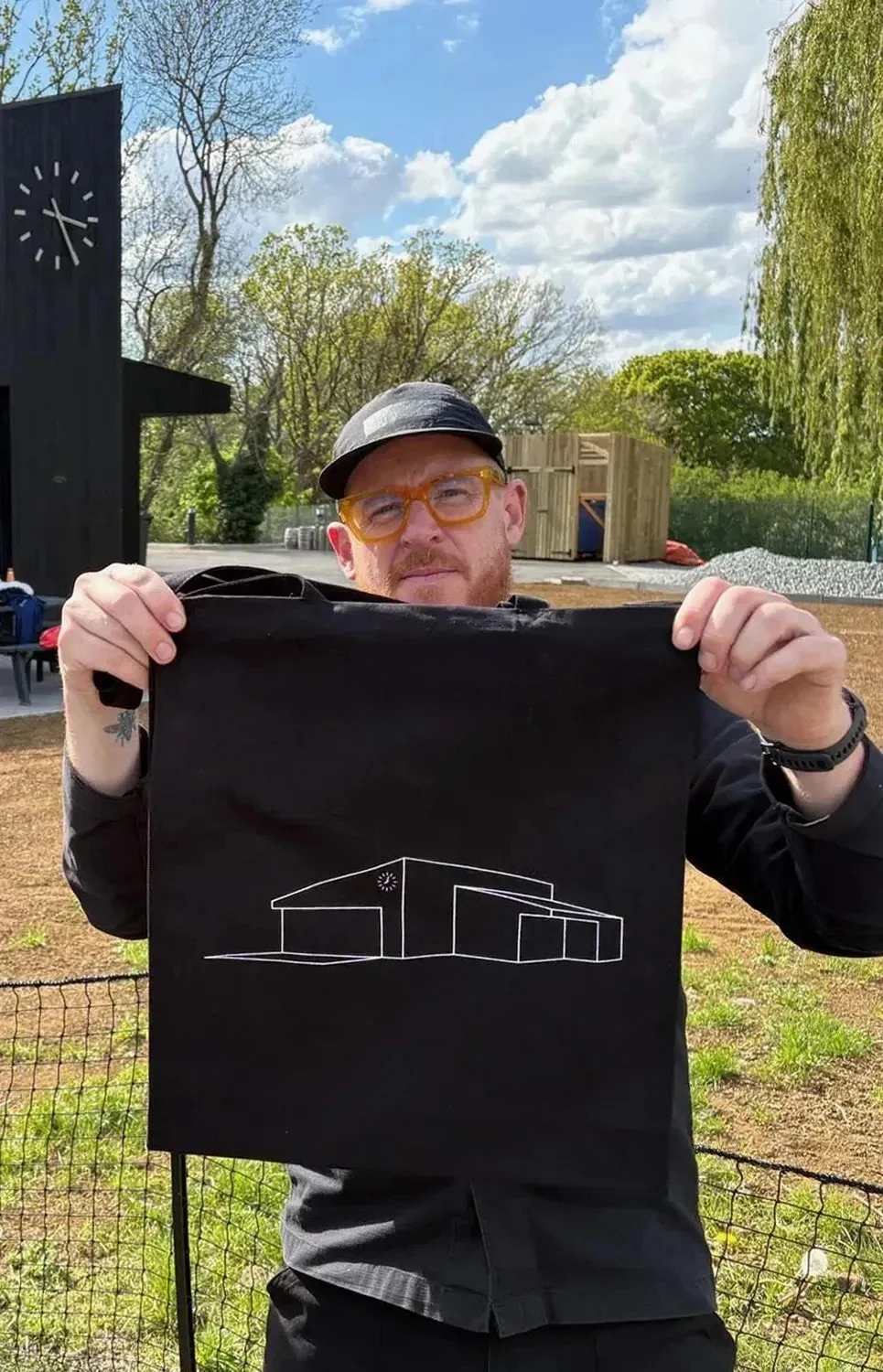 Andy modelling the new tote bags with abstracted cricket pavilion logo. 