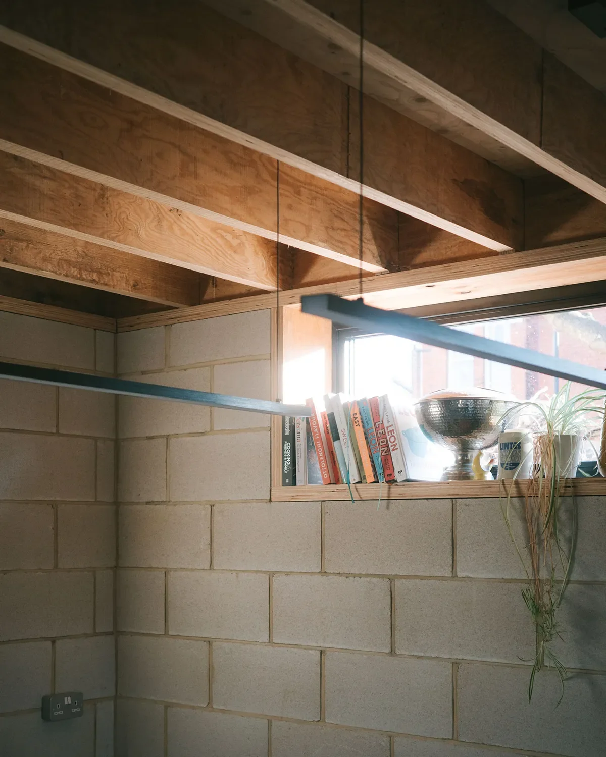 Close up of window, exposed blockwork and LVL timber roof structure. © Andy Matthews Studio