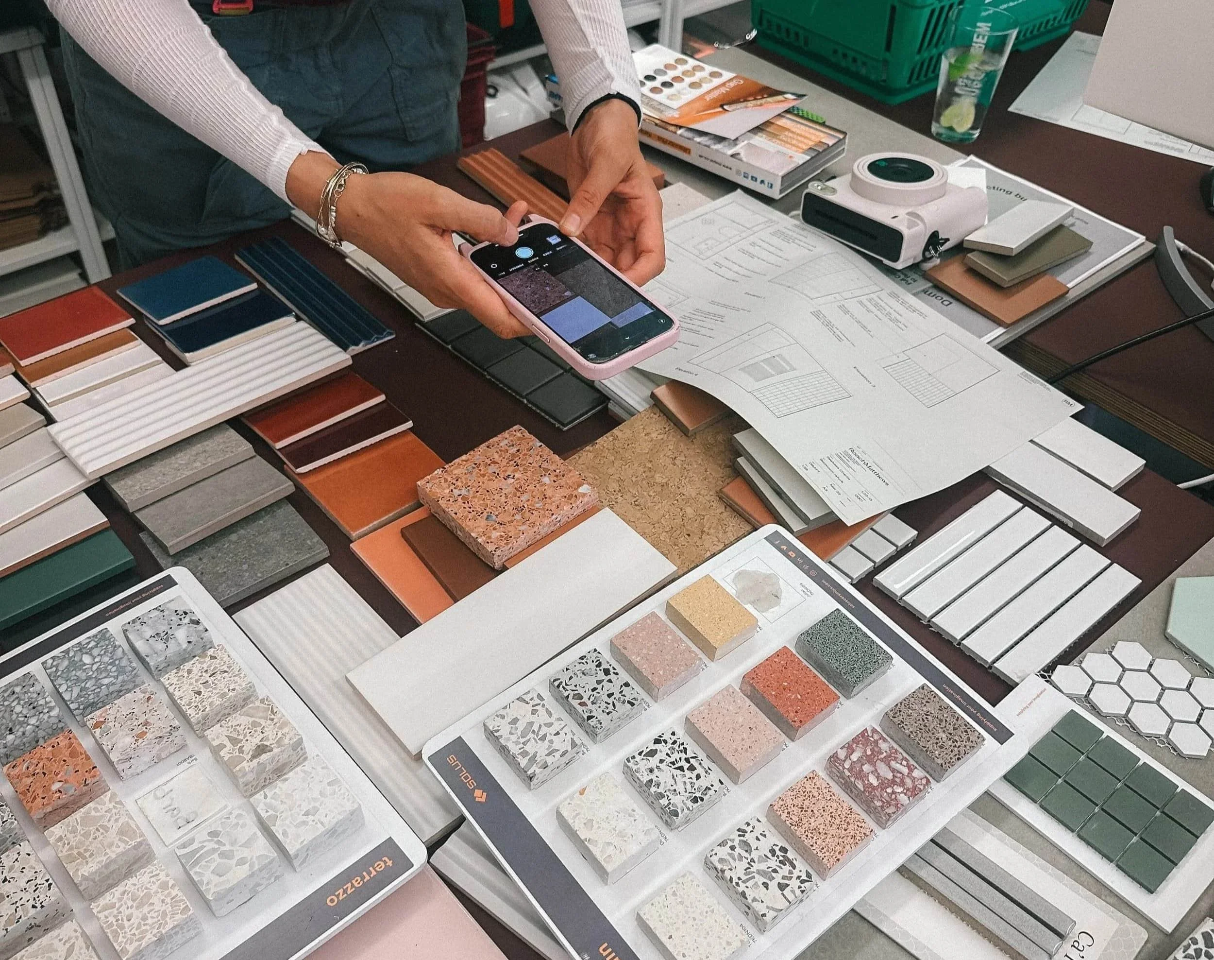 A young woman reviewing physical samples in an architects studio.