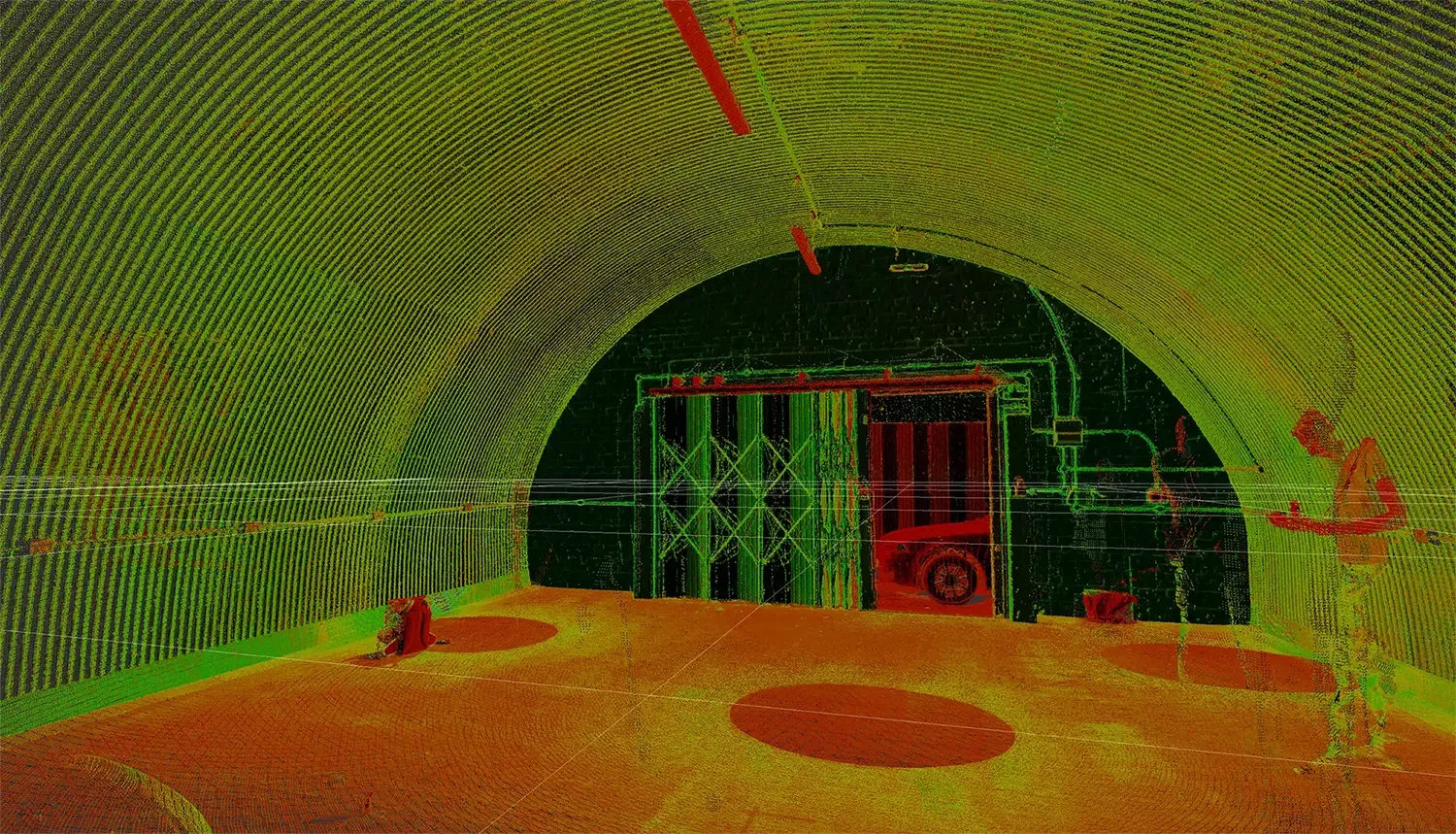 An image from a LiDAR laser scan of a railway arch. The images has dots from the scan and is green and red.