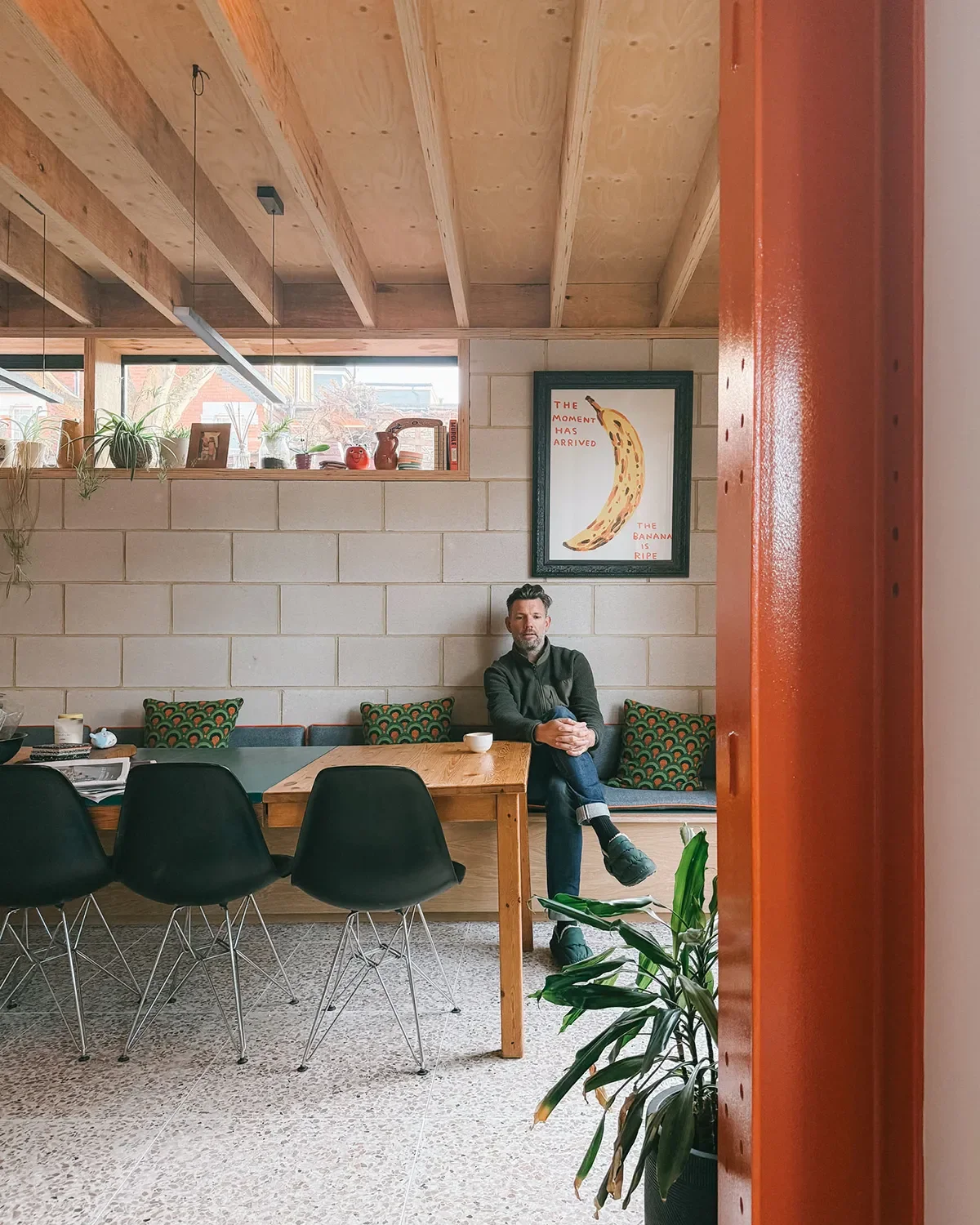 Completed view with client sat on bench seat. Recycled steel in the foreground, with exposed blockwork and LVL timber roof structure also visible. © Andy Matthews Studio