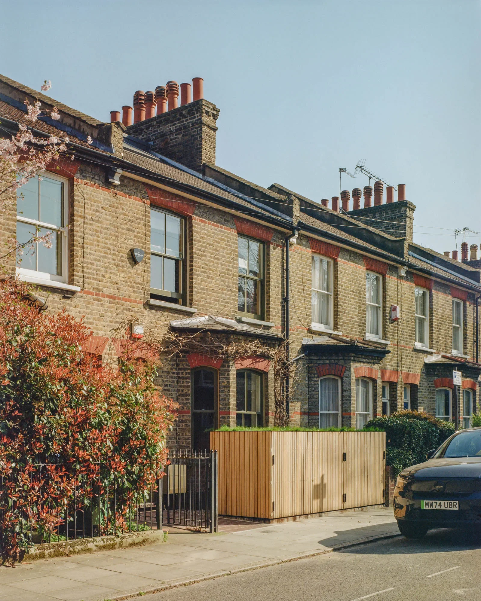 Front elevation with oak clad bike and bin store in the foreground © Owen Vidler