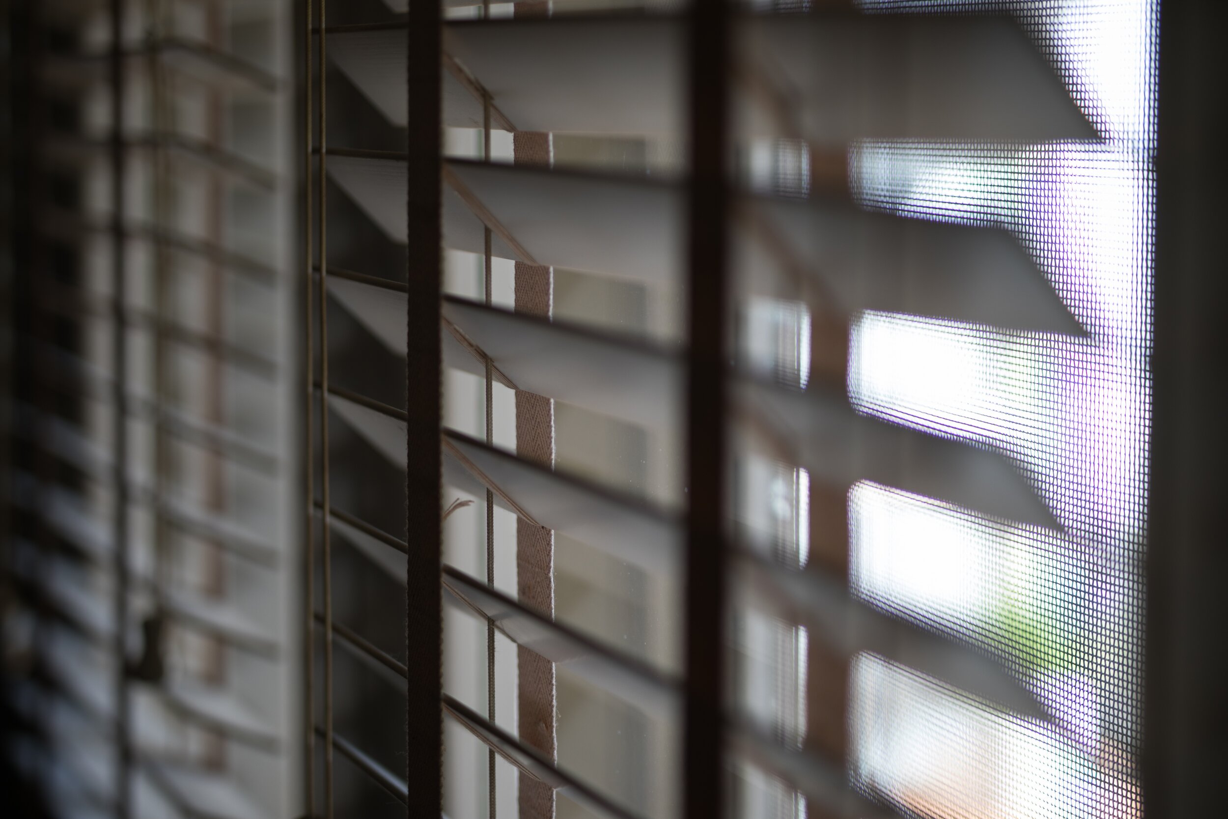 timber-venetian-blinds-on-window-casting-shadows-QDF8HU4.jpg