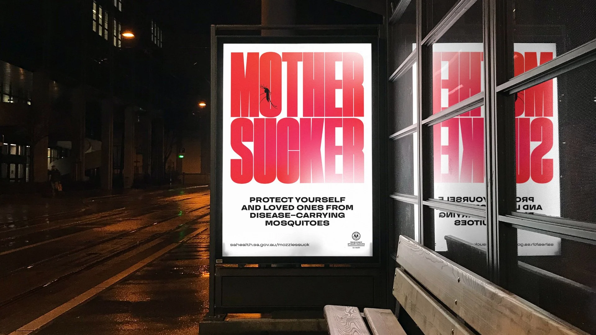 Bus shelter advertisement with bold red text that reads 'MOTHER SUCKER'. Below, smaller black text says 'Protect yourself and loved ones from disease—carrying mosquitoes.' The advertisement includes a website URL and the logo of the Government of Sou