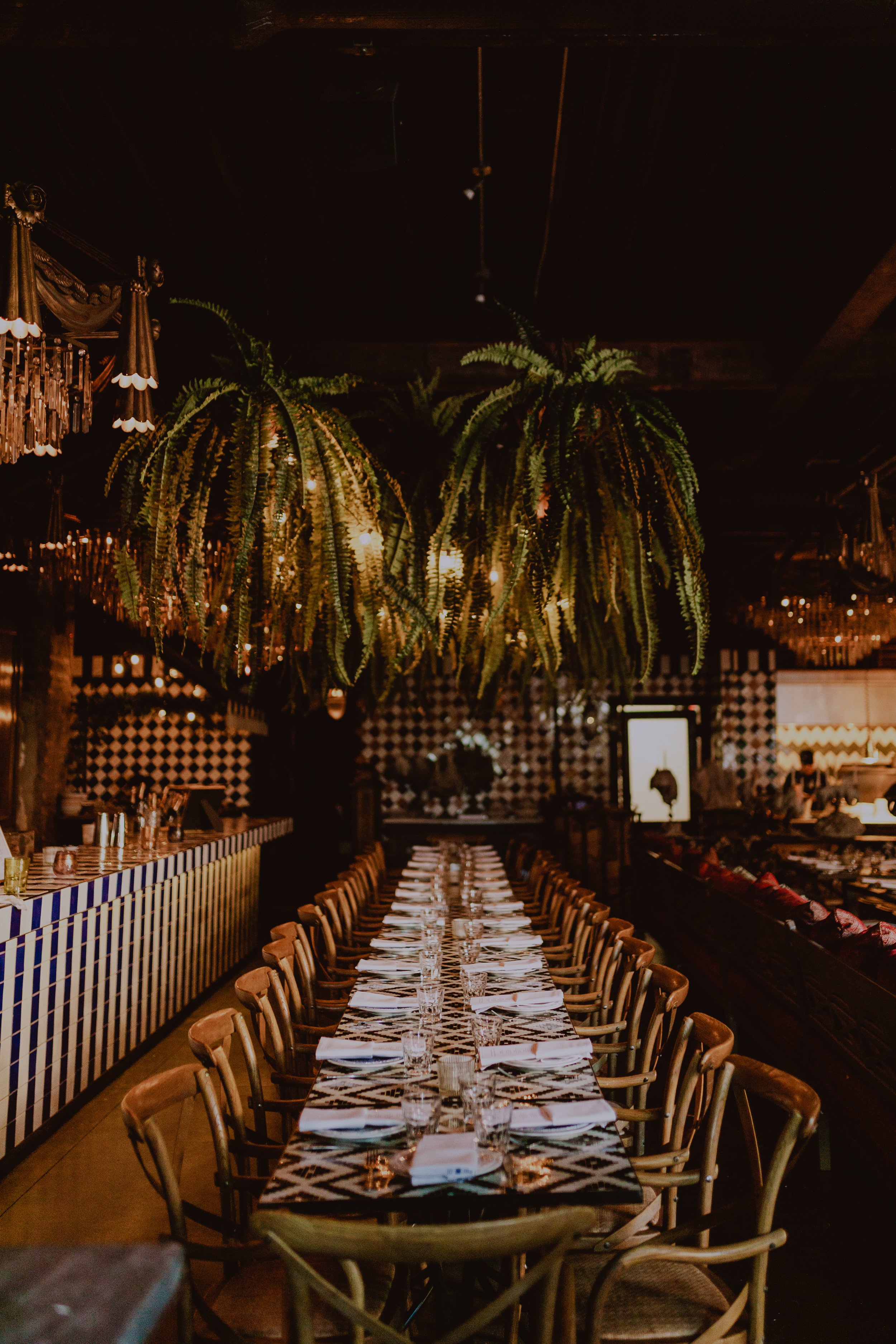 Ferns, Candle light, chandeliers, checkered tile wedding reception