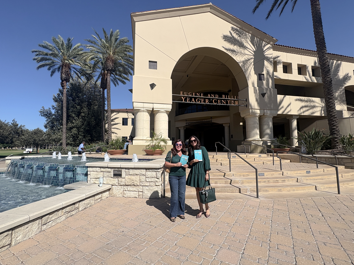 Rachel and Liselle holding their book outside of CBU