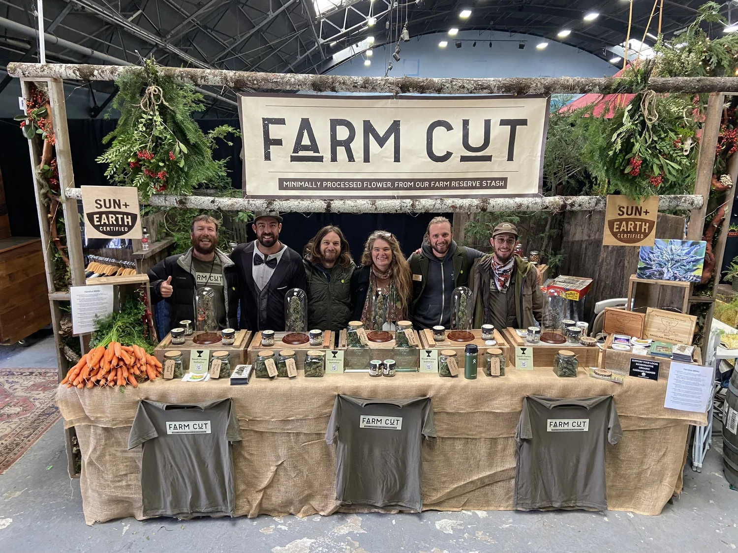 FarmCut growers together at their booth beneath the Farm Cut banner