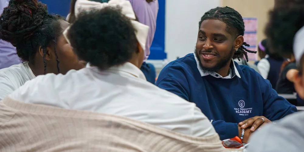 A male teacher working with students