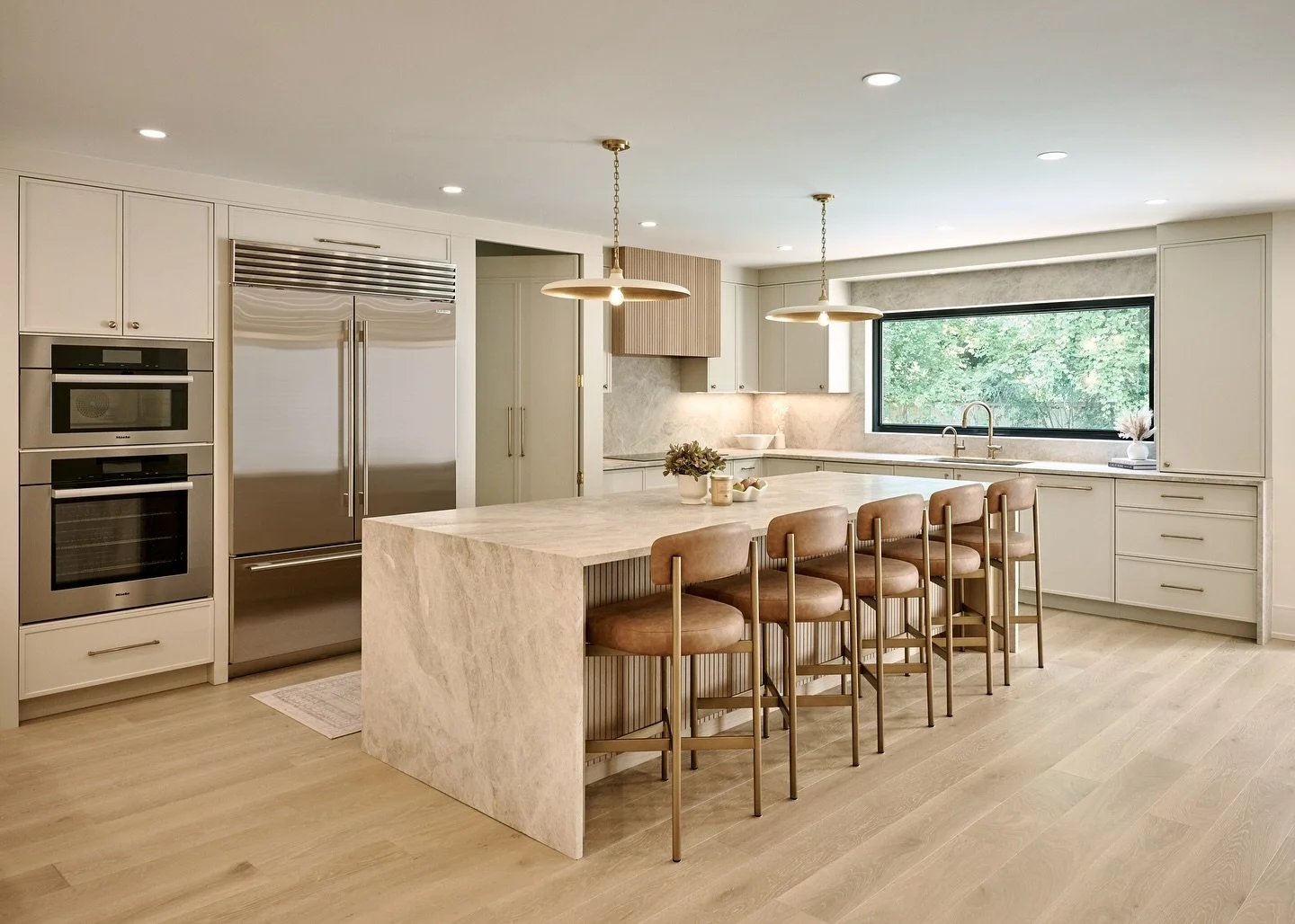 From outdated to elevated!  This kitchen got a full transformation! 
We reimagined the space with structural changes, custom millwork, a brighter layout, warm finishes, and modern storage solutions. 
➡️ Swipe to see the the before 👀 does it even lo