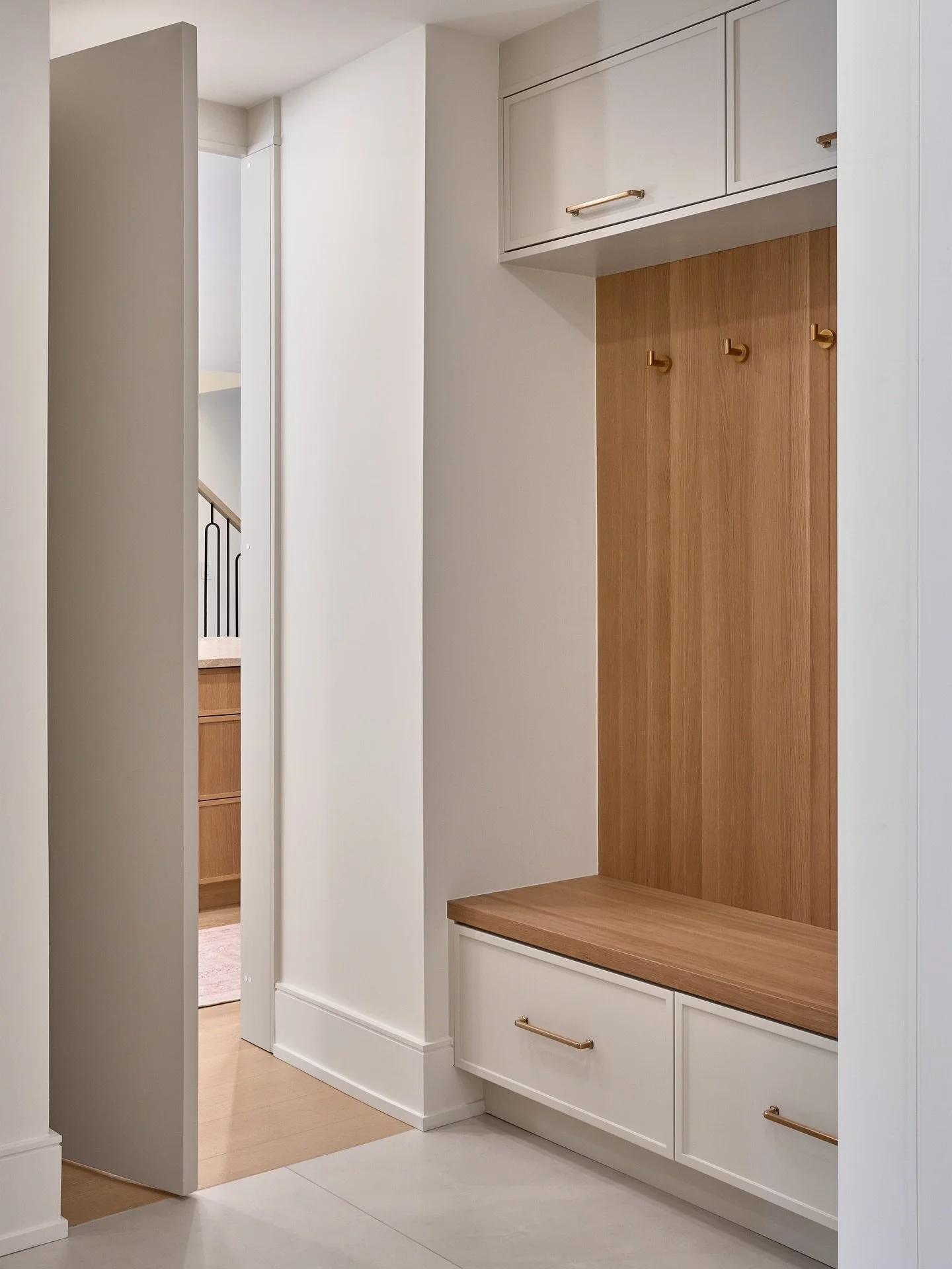 Smart storage meets subtle style.  This mudroom is the perfect blend of function and beauty, hidden door from the kitchen, warm wood accents and tailored details that make coming home feel effortless. 
A functional space that feels just as beautiful