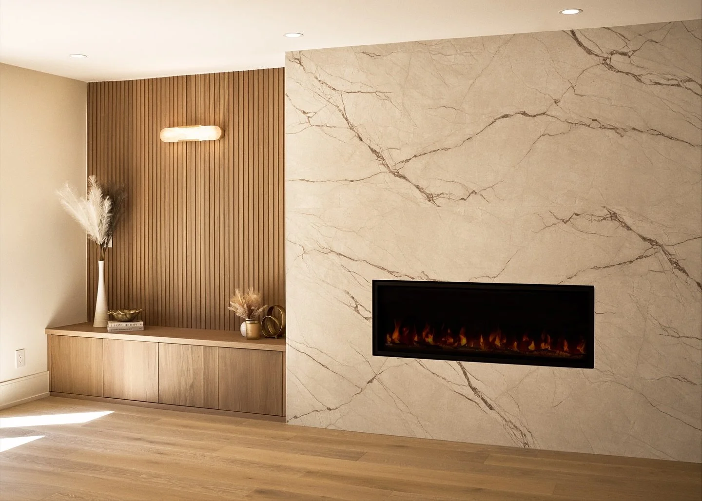 Feature wall transformation!  This fireplace wall had great presence, but the heavy stone dated the space. We relocated and reimagined it with modern lines and layered textures to create a focal point that feels both elevated and inviting. ➡️ to see