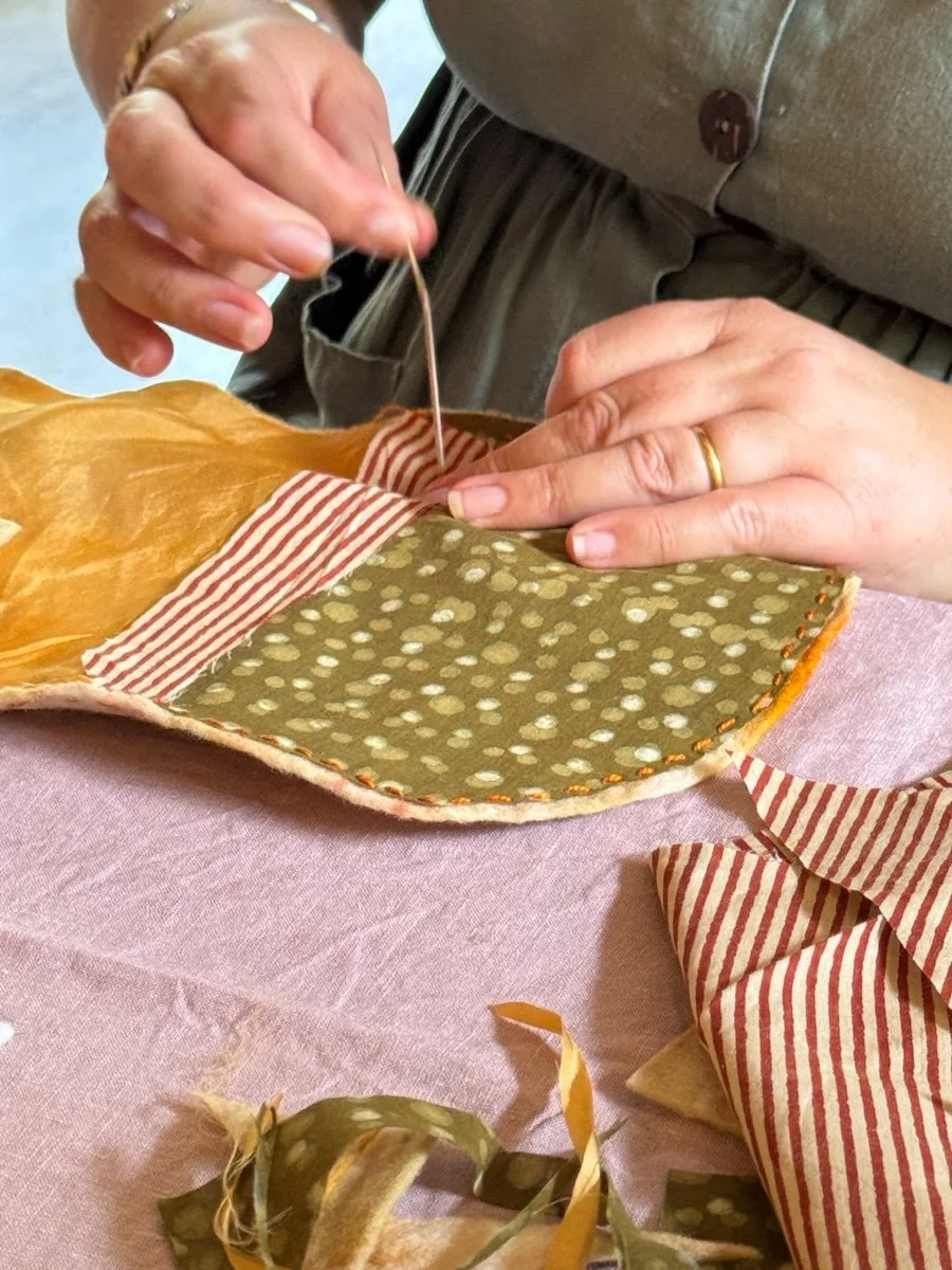 hand sewing a felt naturally dyed pouch by Petalplum student.JPG
