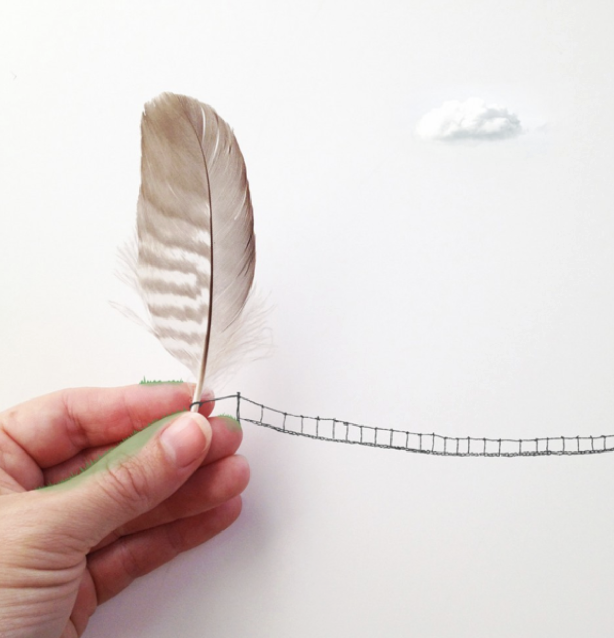 a white woman's hand holds a grey striped bird feather. a hand drawn bridge is suspended from the feather