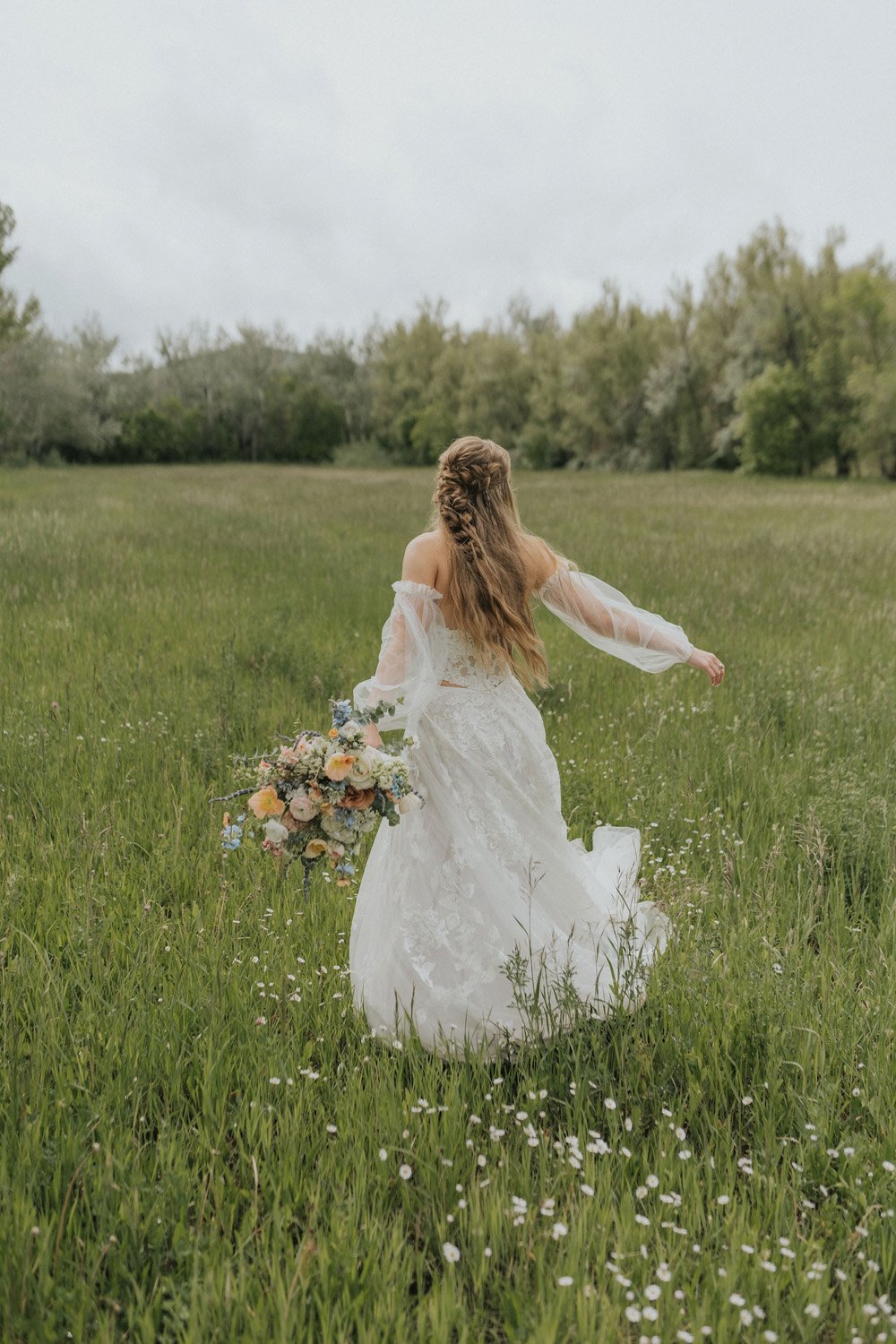 Plume&Furrow-Wedding-Florist-theMandinos-AbbyRindelPhoto-LoneHawk-Farm-Colorado-June-bride-running-in-field-with-bouquet.jpg