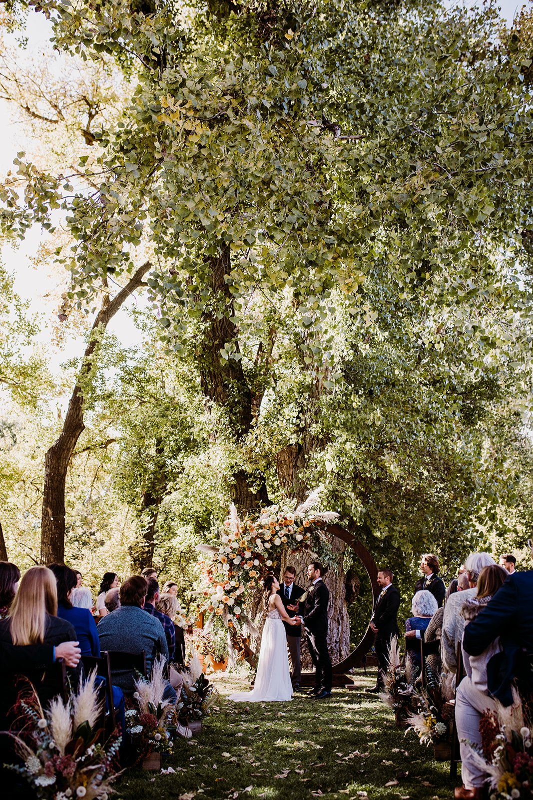 Plume&Furrow-WeddingFlorist-Garrison&Gabriella-TaylerCarlisle-Lyons-Farmette-October-Colorado-Bride-Groom-Ceremony-Arch-Wideshot.jpg