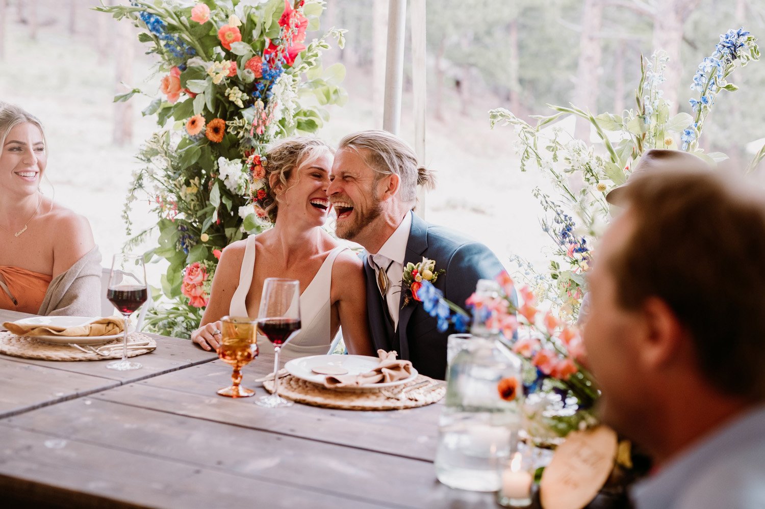 Plume&Furrow-Wedding-Florist-Talie&Forrest-Boulder-County-Colorado-TaylerCarlisle-bride-groom-toasts-laughter-flowers.jpg