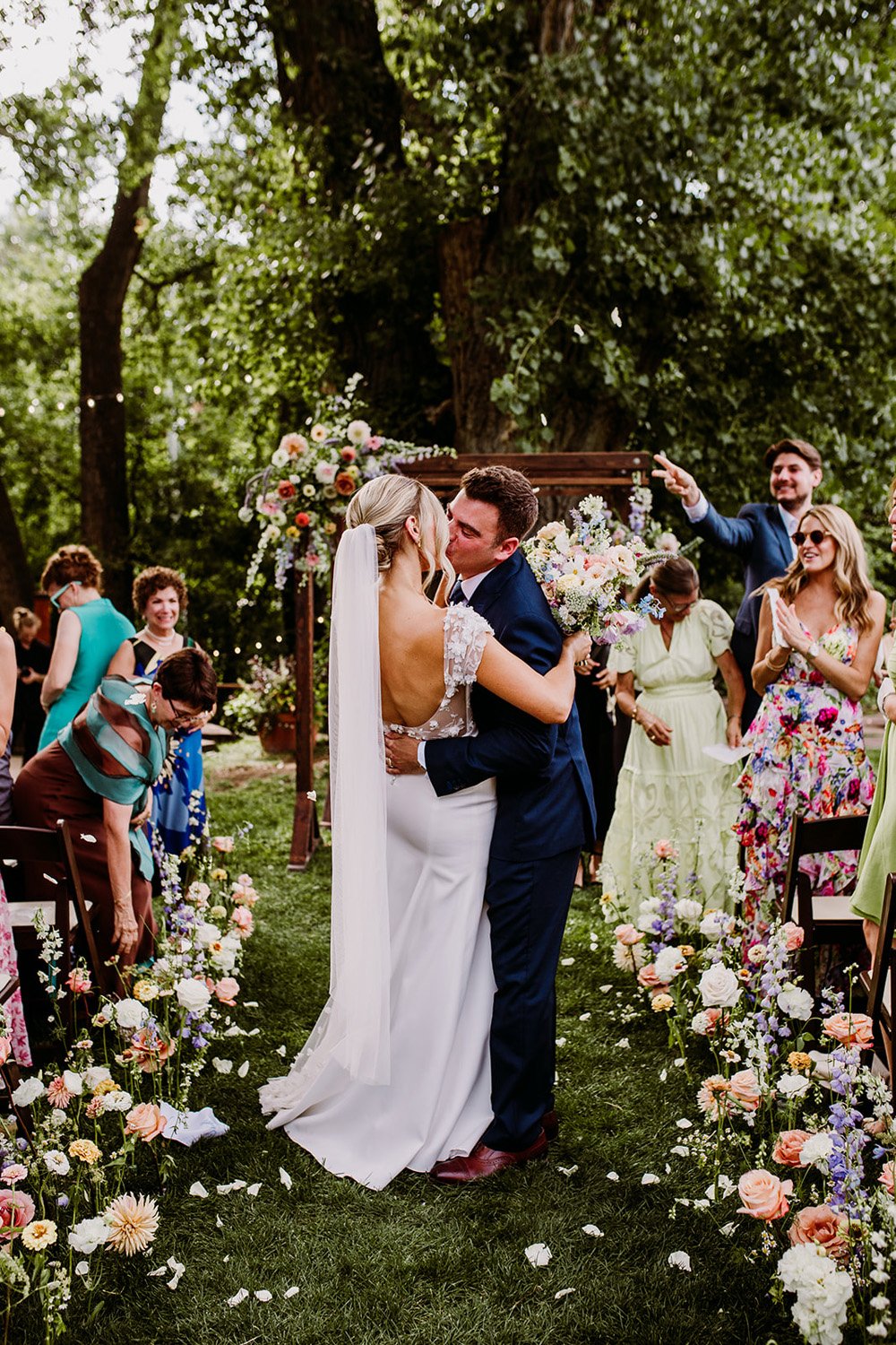 Plume&Furrow-Colorado-Wedding-Florist-Emily&Charlie-TaylerCarlislePhoto-Farmette-September-ceremony-just-married-kiss.jpg