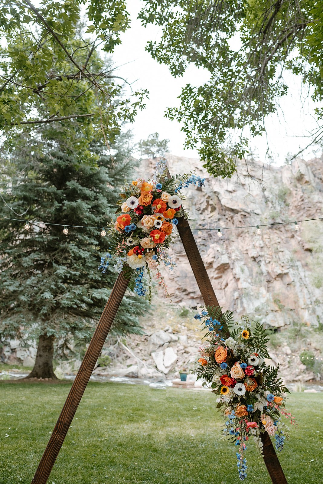 Plume&Furrow-Wedding-Florist-Meg&Cary-MapandCompassPhotography-River-Bend-June-Colorado-Triangle-Arbor-Ceremony-Spray.jpg