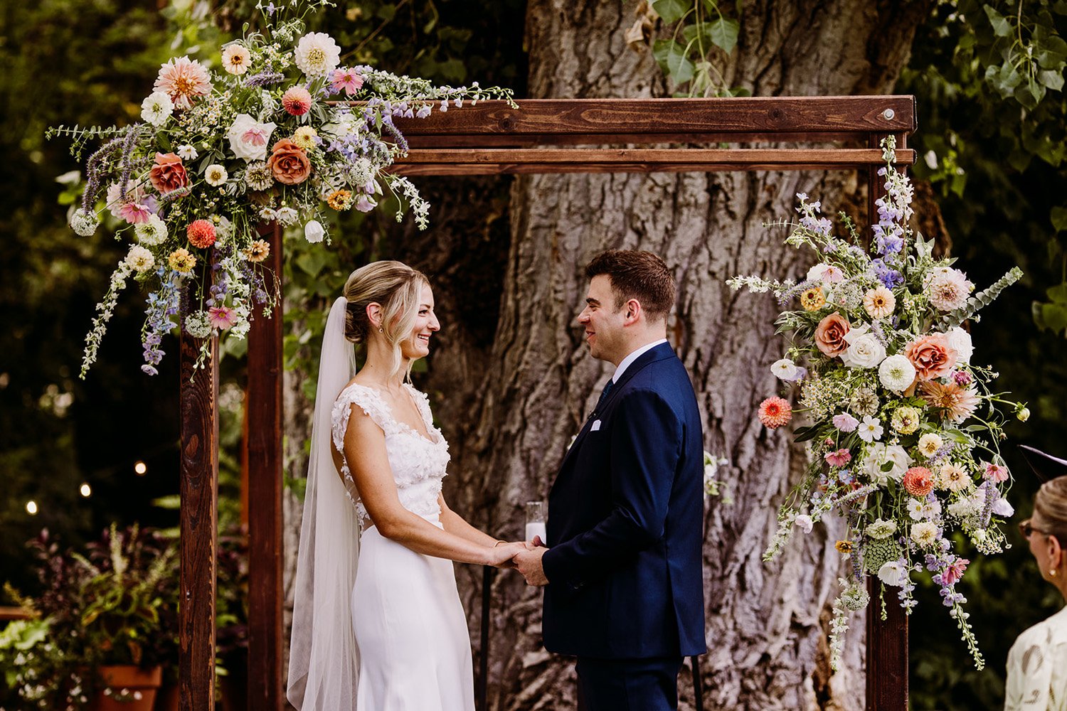 Plume&Furrow-Colorado-Wedding-Florist-Emily&Charlie-TaylerCarlislePhoto-Farmette-September-ceremony-arbor-flowers-vows.jpg