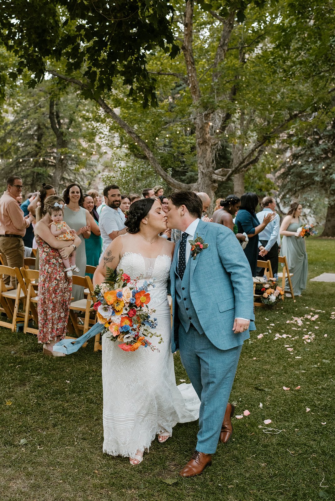 Plume&Furrow-Wedding-Florist-Meg&Cary-MapandCompassPhotography-River-Bend-June-Colorado-Aisle-Kiss-Couple.jpg