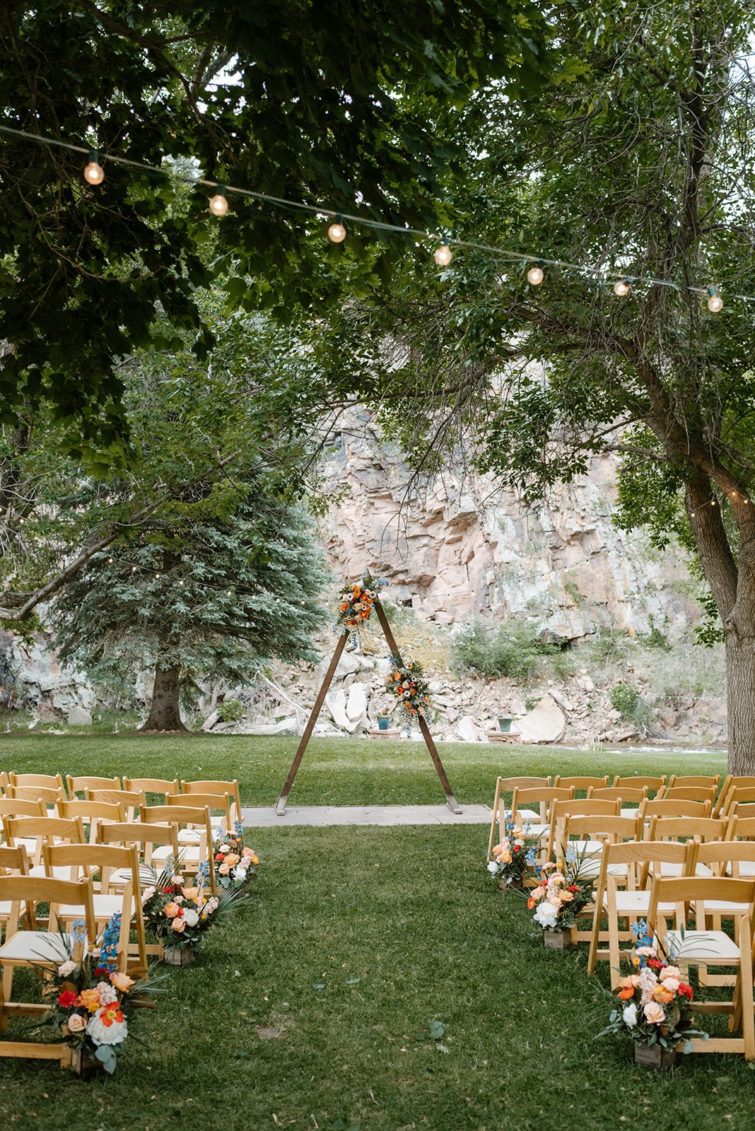 Plume&Furrow-Wedding-Florist-Meg&Cary-MapandCompassPhotography-River-Bend-June-Colorado-Ceremony-Triangle-Arbor-Aisle-Decor.jpg