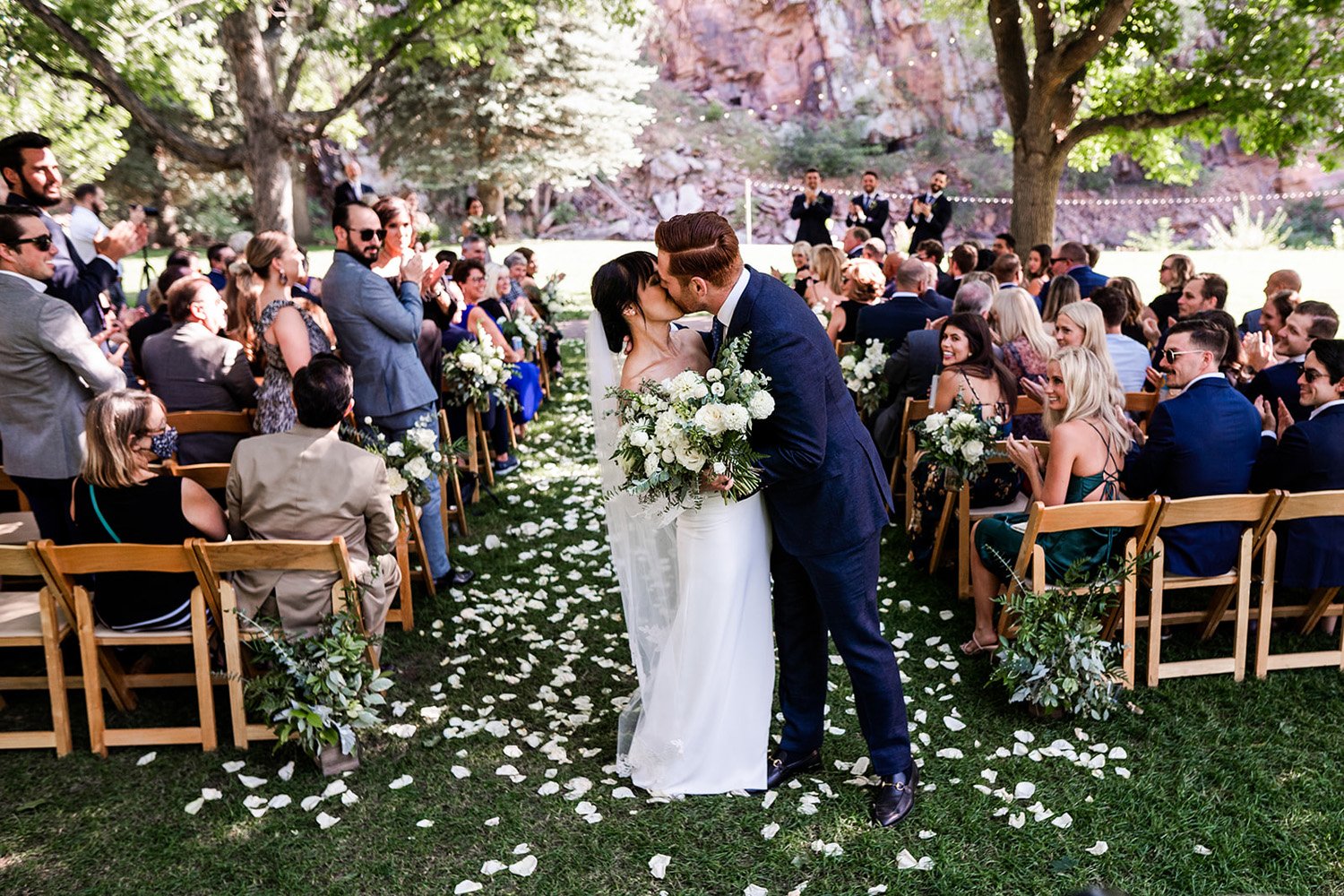 Plume&Furrow-Wedding-Florist-Megan&Jack-TaylerCarlislePhoto-RiverBend-August-Colorado-ceremony-just-married-kiss.jpg