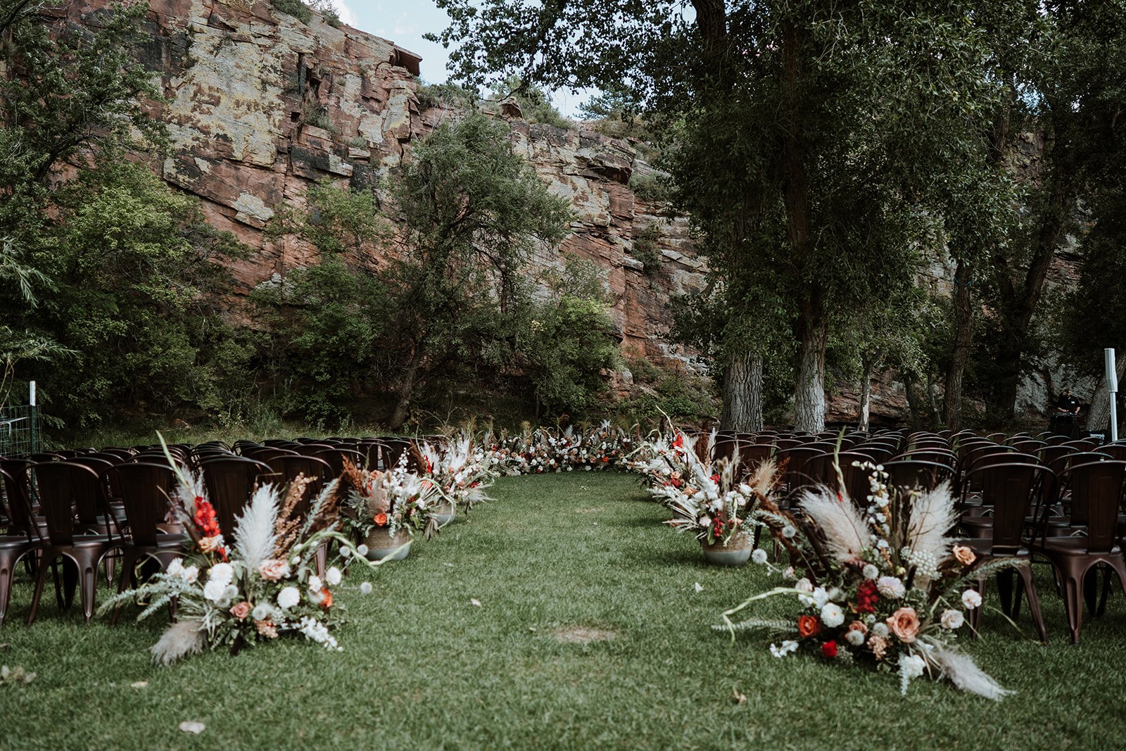Plume&Furrow-Wedding-Florist-Jess&Jonny-BasecampVisual-Planet-Bluegrass-August-Colorado-Ceremony-Aisle-Wide-Shot.jpg