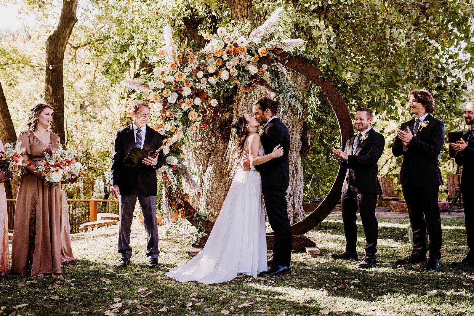 Plume&Furrow-WeddingFlorist-Garrison&Gabriella-TaylerCarlisle-Lyons-Farmette-October-Colorado-Bride-Groom-Ceremony-Arbor-Kiss.jpg