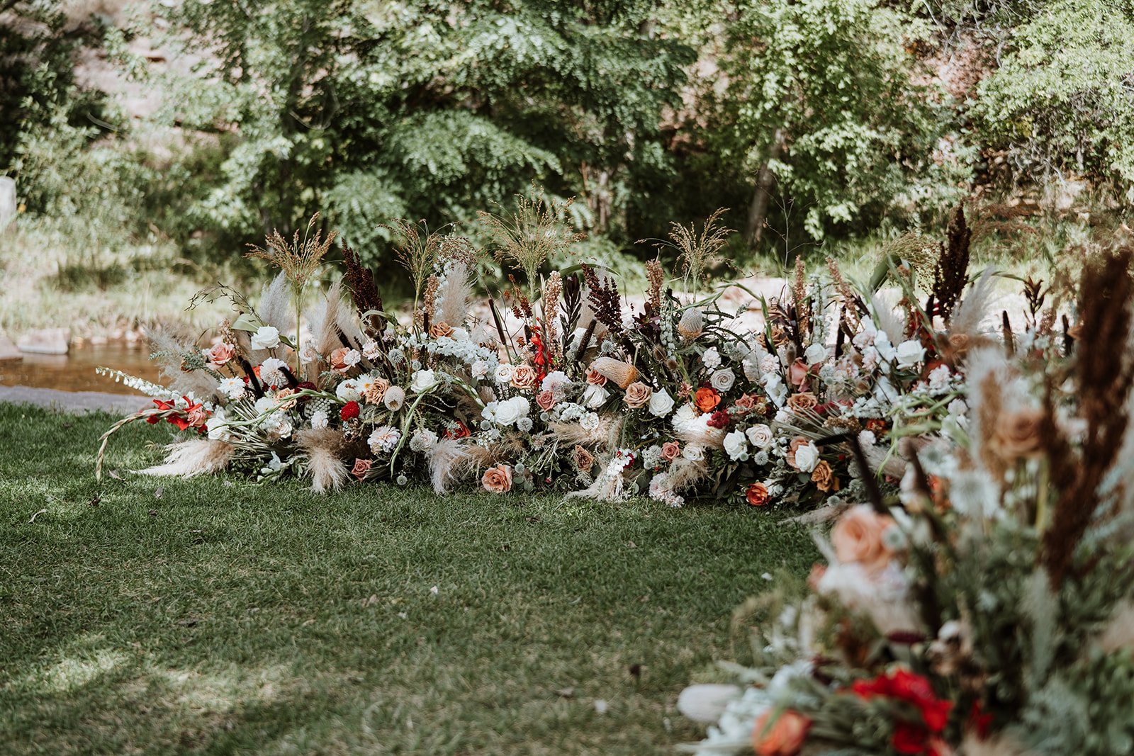 Plume&Furrow-Wedding-Florist-Jess&Jonny-BasecampVisual-Planet-Bluegrass-August-Colorado-Ceremony-Decor-Ground-Arch-Riverside.jpg