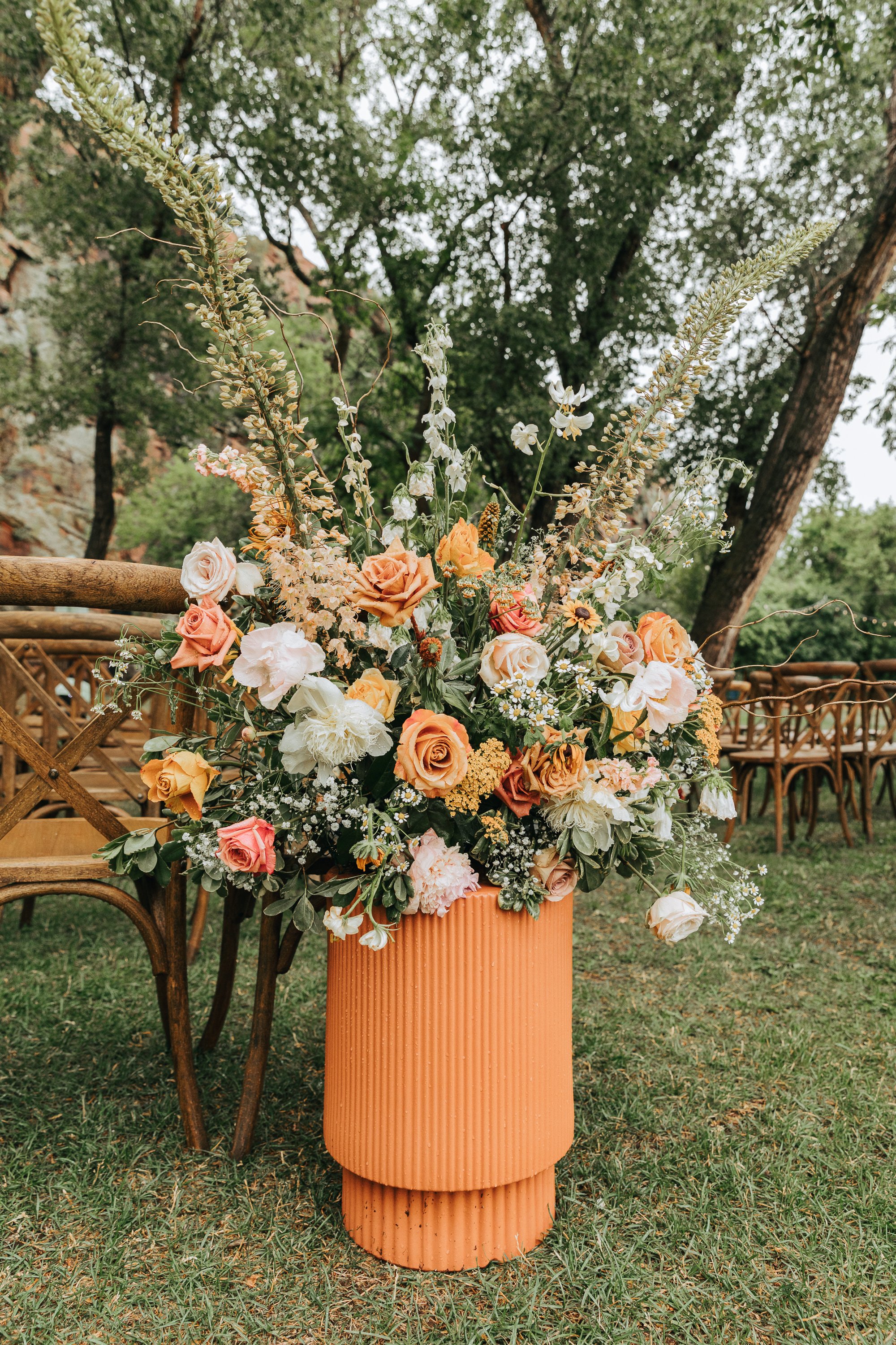 Plume&Furrow-WeddingFlorist-Katie&Worth-AliciaDelia-Planet-Bluegrass-July-Colorado-Aisle-Arrangement-Terracotta-Stand.jpg