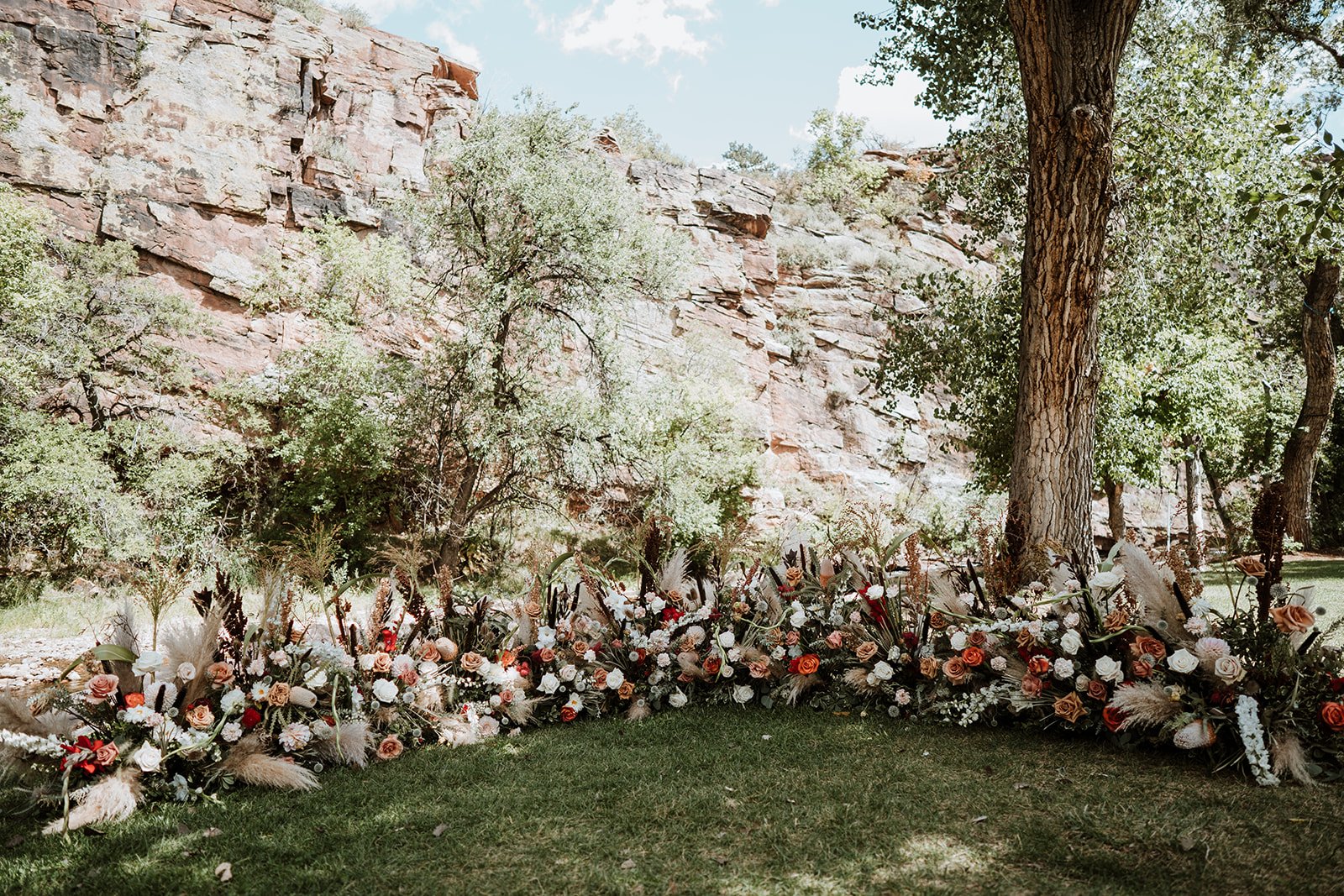 Plume&Furrow-Wedding-Florist-Jess&Jonny-BasecampVisual-Planet-Bluegrass-August-Colorado-Ceremony-Ground-Arch-Under-Trees.jpg