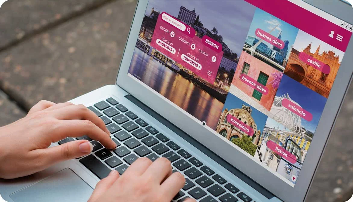A person using a laptop to browse vacation destinations on a generic digital travel marketplace platform, illustrating how digitized inventory connects tour operators to global consumer demand.