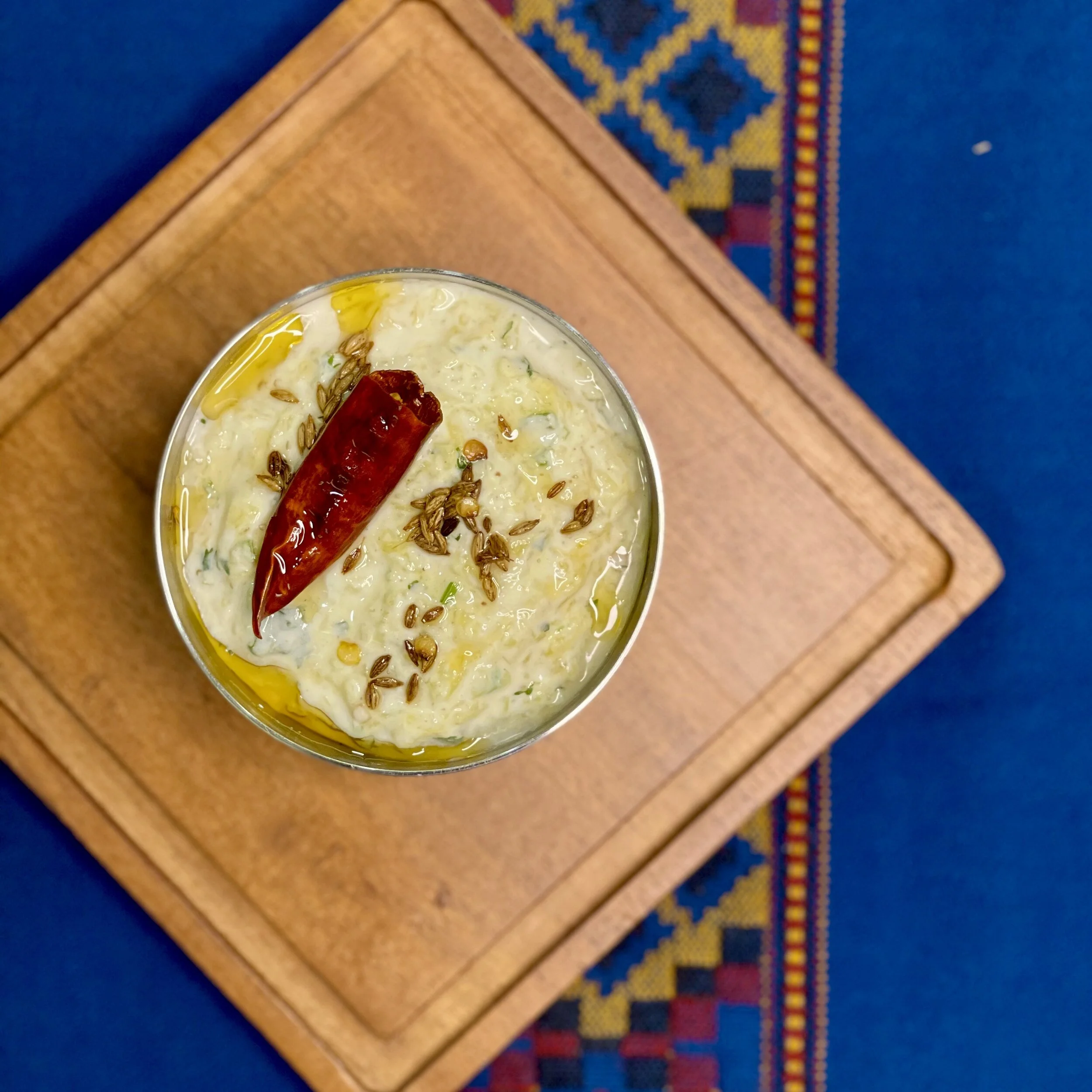 pumpkin raita100g pumpkin, boiled, drained, mashed  100g whisked yogurt  ¼ tsp salt  ¼ tsp roasted cumin powder  1 green chilli, minced 1 tsp finely chopped cilantro tadka optional: heat 1 tsp oil and crackle 1 dried red chi…