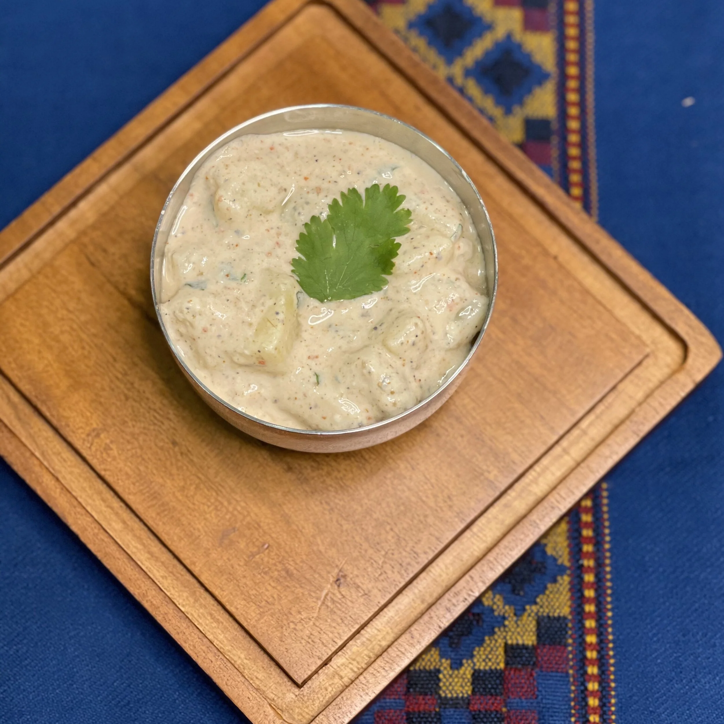 potato raita100g potato, peeled, small cubes, boiled 100g whisked yogurt  ¼ tsp salt  ¼ tsp roasted cumin powder ¼ tsp chilli powder  ¼ tsp pepper  1 tsp finely chopped cilantro