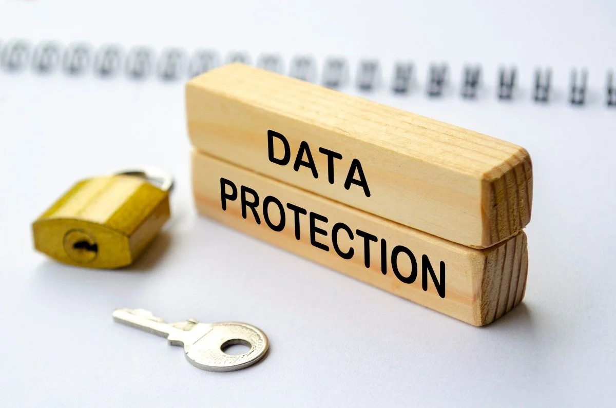 words data protection on two wooden blocks with a padlock and key