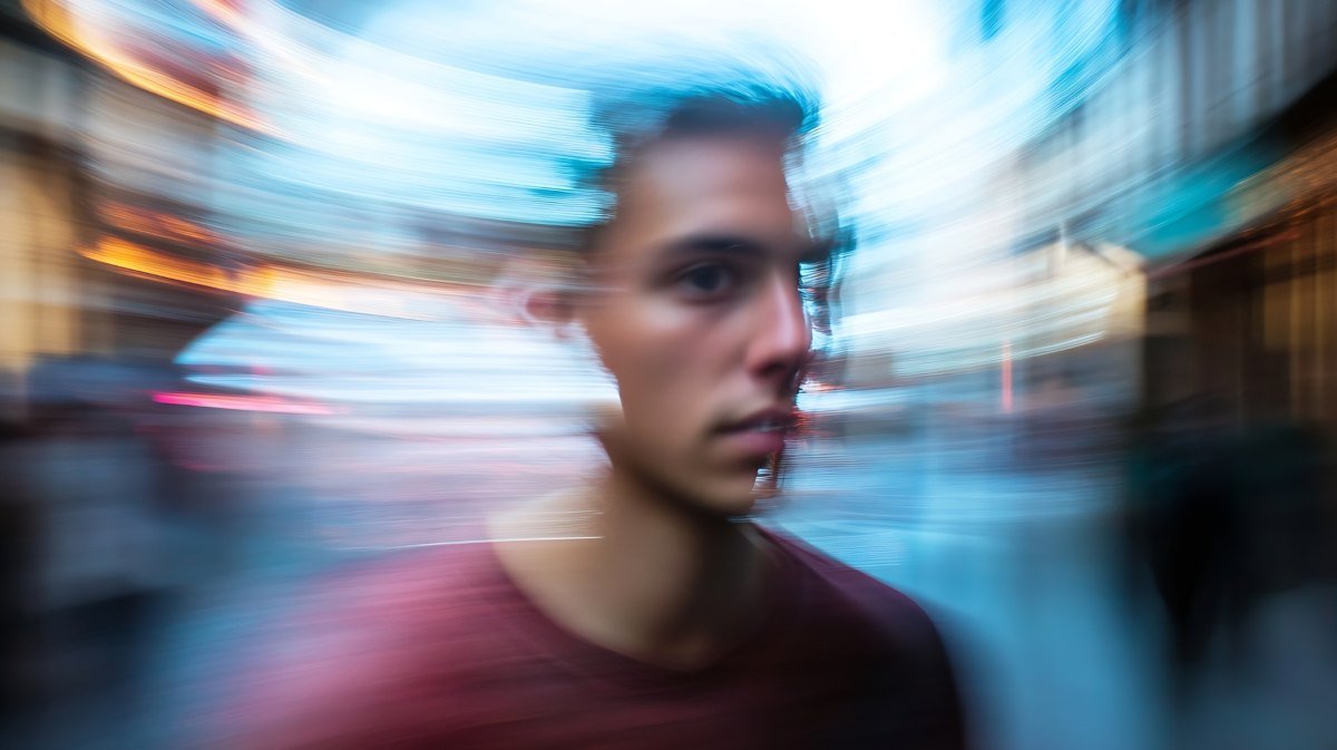 Young Man with Artistic Motion Blur Effect in a Busy Urban Setting
