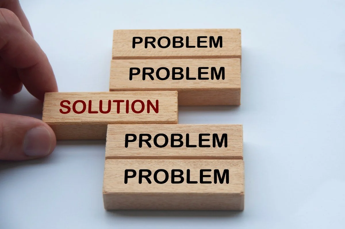 small wooden blocks with the words problem and solution printed