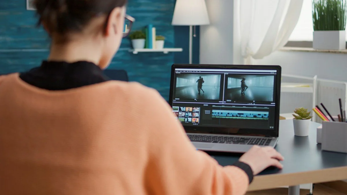 Student learning to edit multimedia footage at online class lesson, film editor
