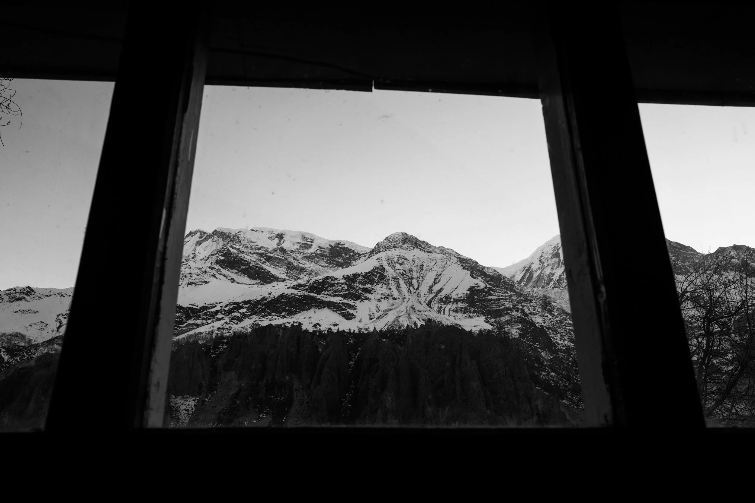 A view through a window to a Swiss Alpine
