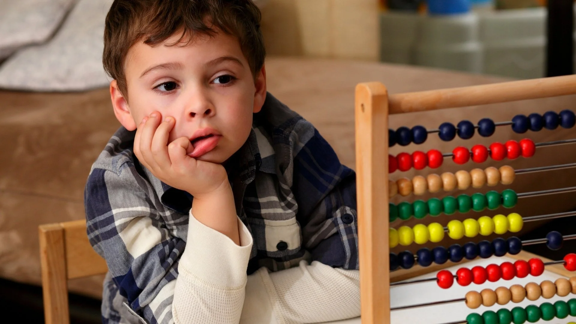 child siting at a desk looking bored
