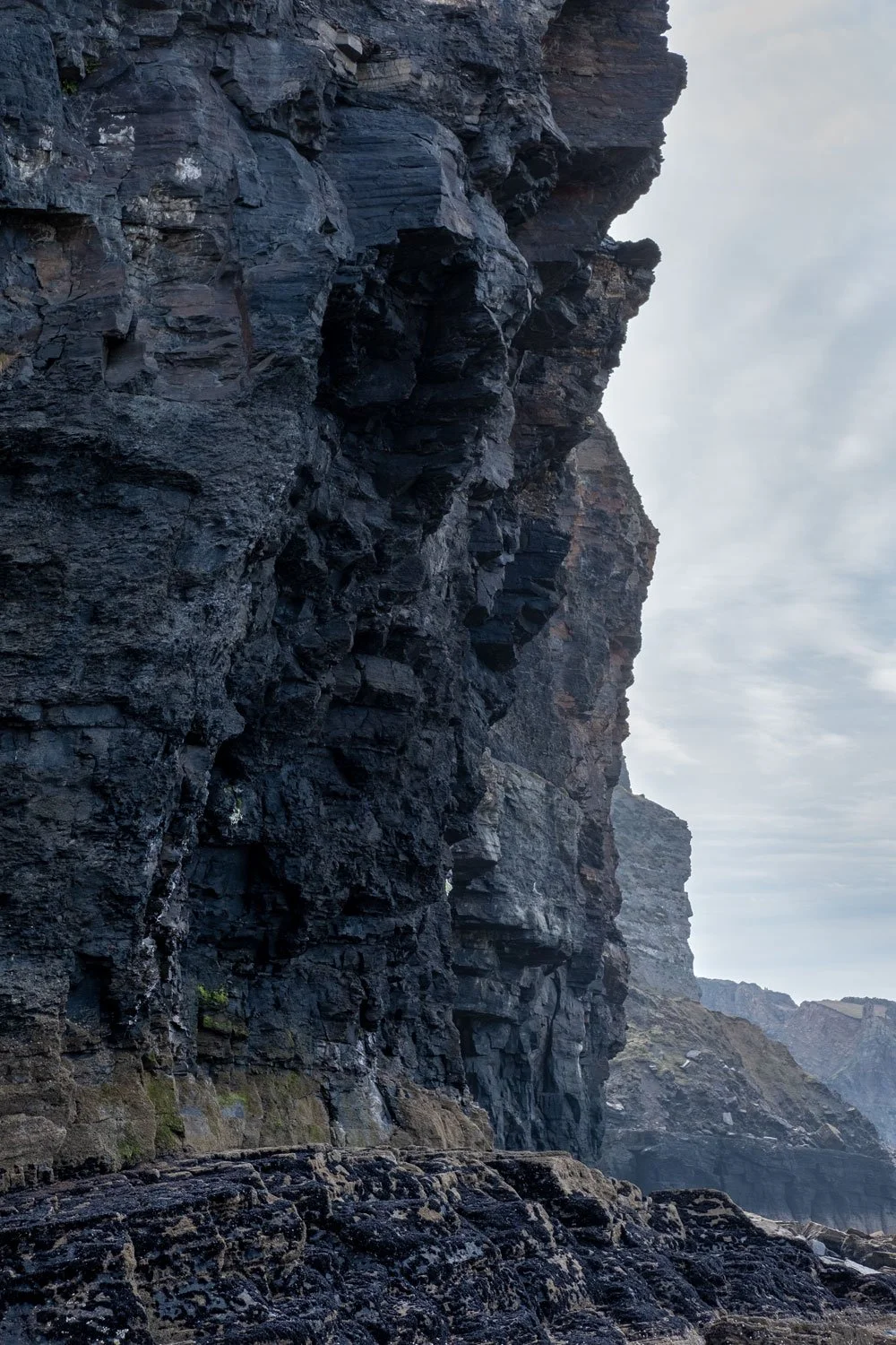 Hidden caves at the foot of the cliffs.