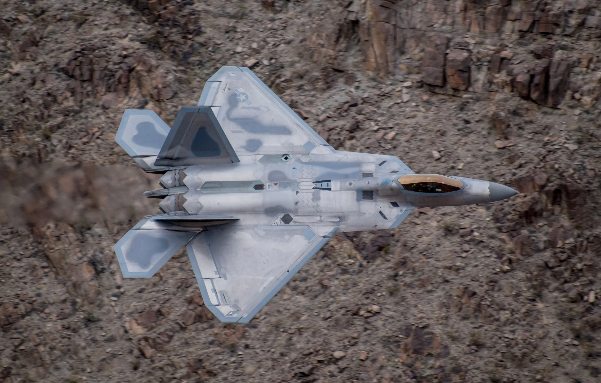 An F-22 based out of Edwards Air Force Base flies through a canyon near Death Valley.