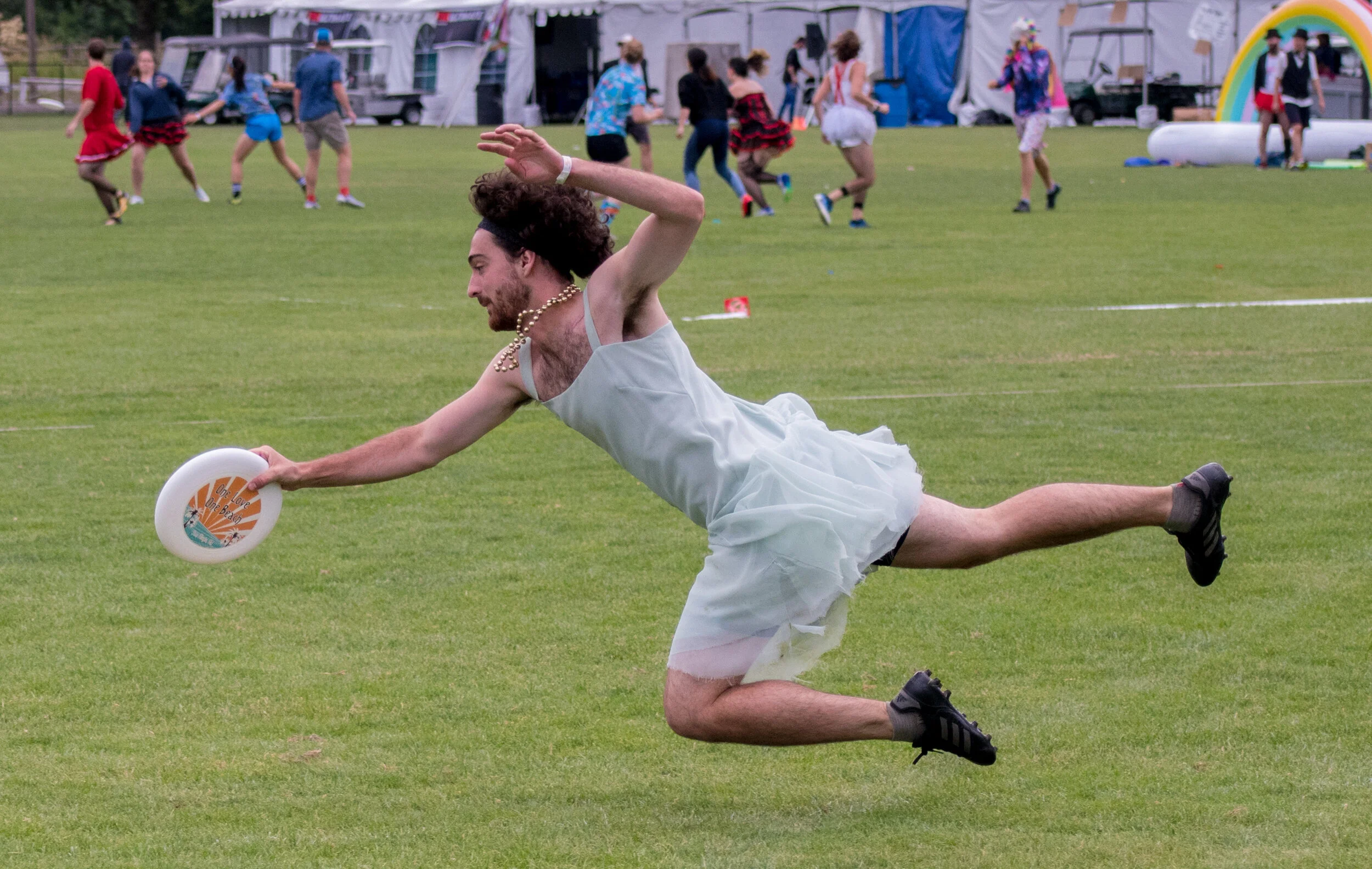 A frisbee player lays out for a catch at the Sunbreak Frisbee tournament.