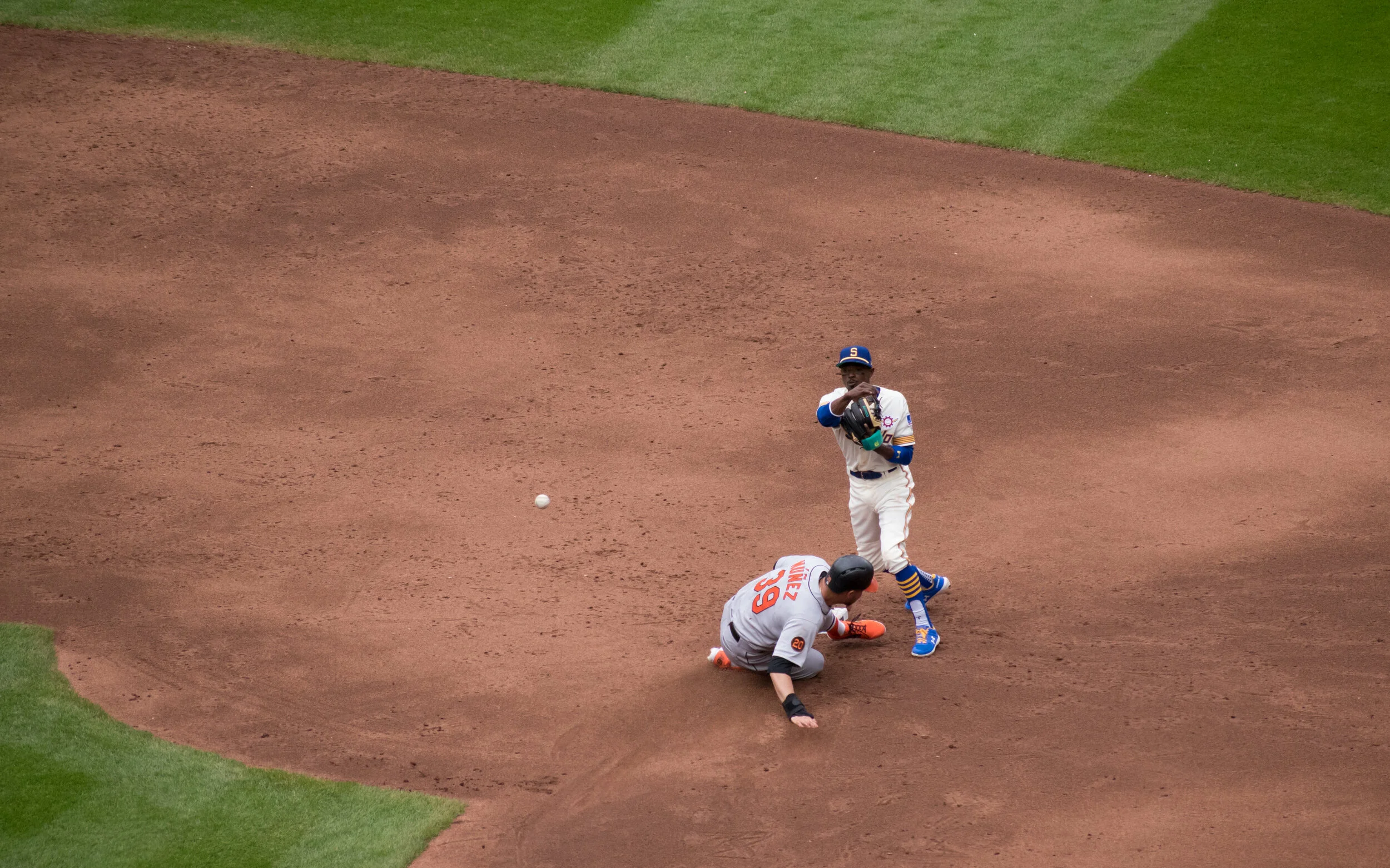Mariners second baseman Dee Strange-Gordon turns a double play against Baltimore.