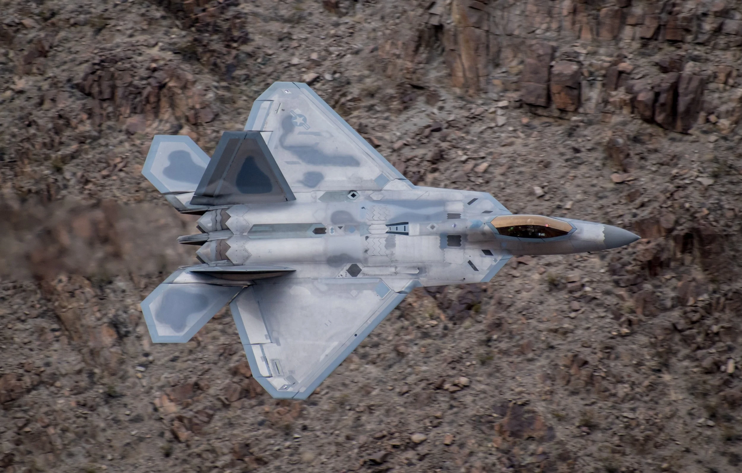 An F-22 based out of Edwards Air Force Base flies through a canyon near Death Valley, California.