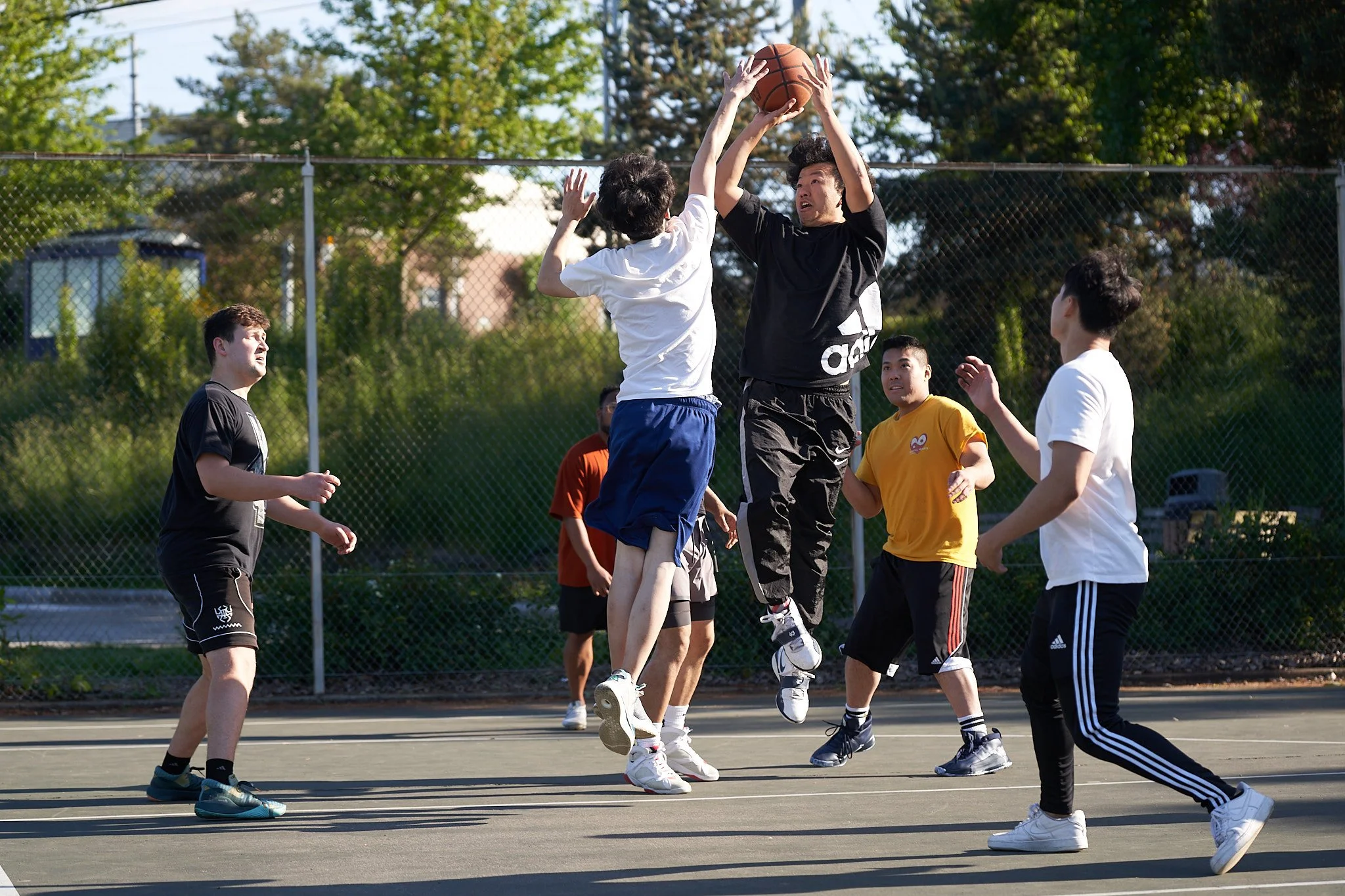 Peter He takes a jumpshot at Van Asselt Playfield.