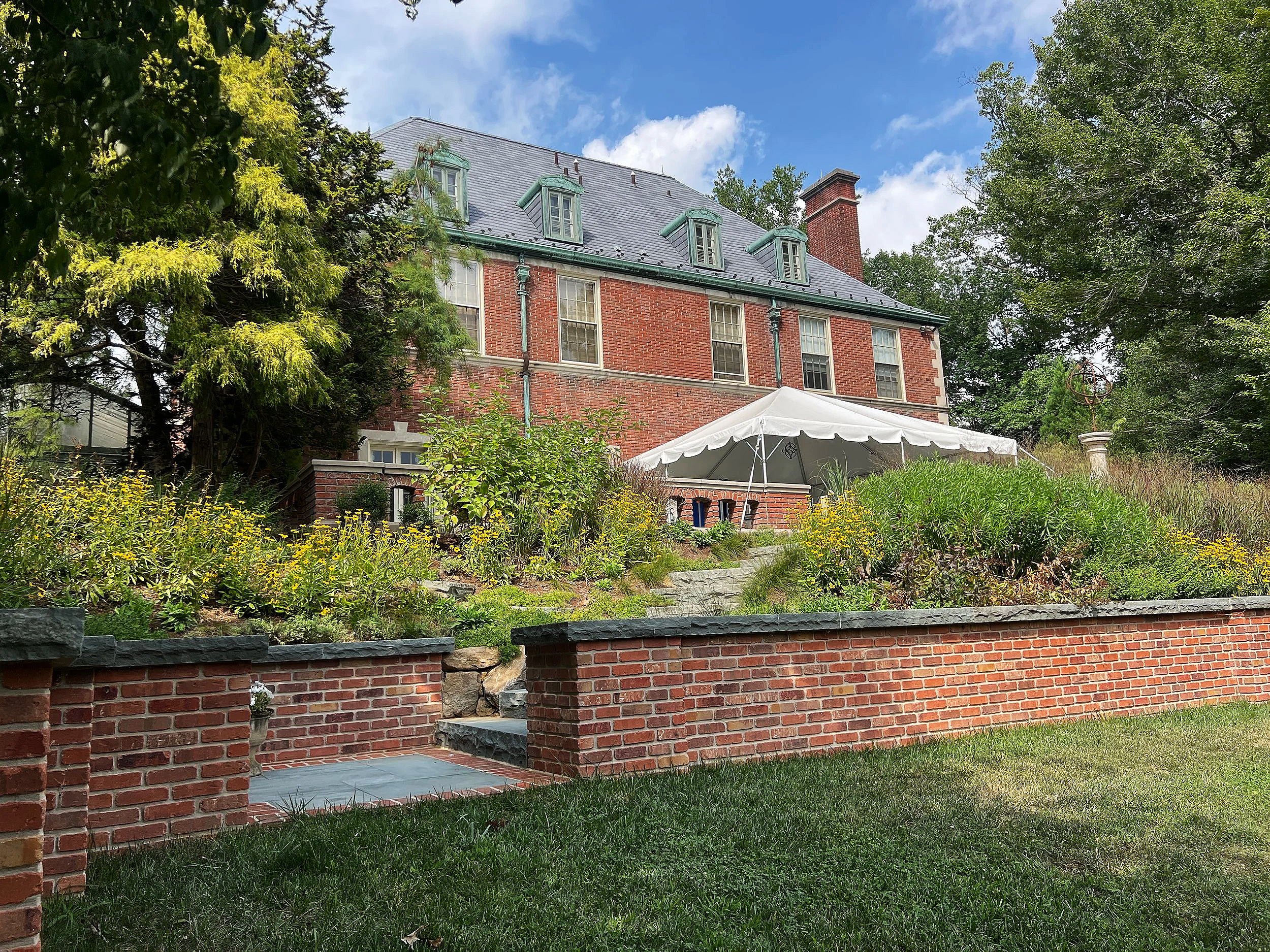 Bluestone-capped brick walls frame lush plantings