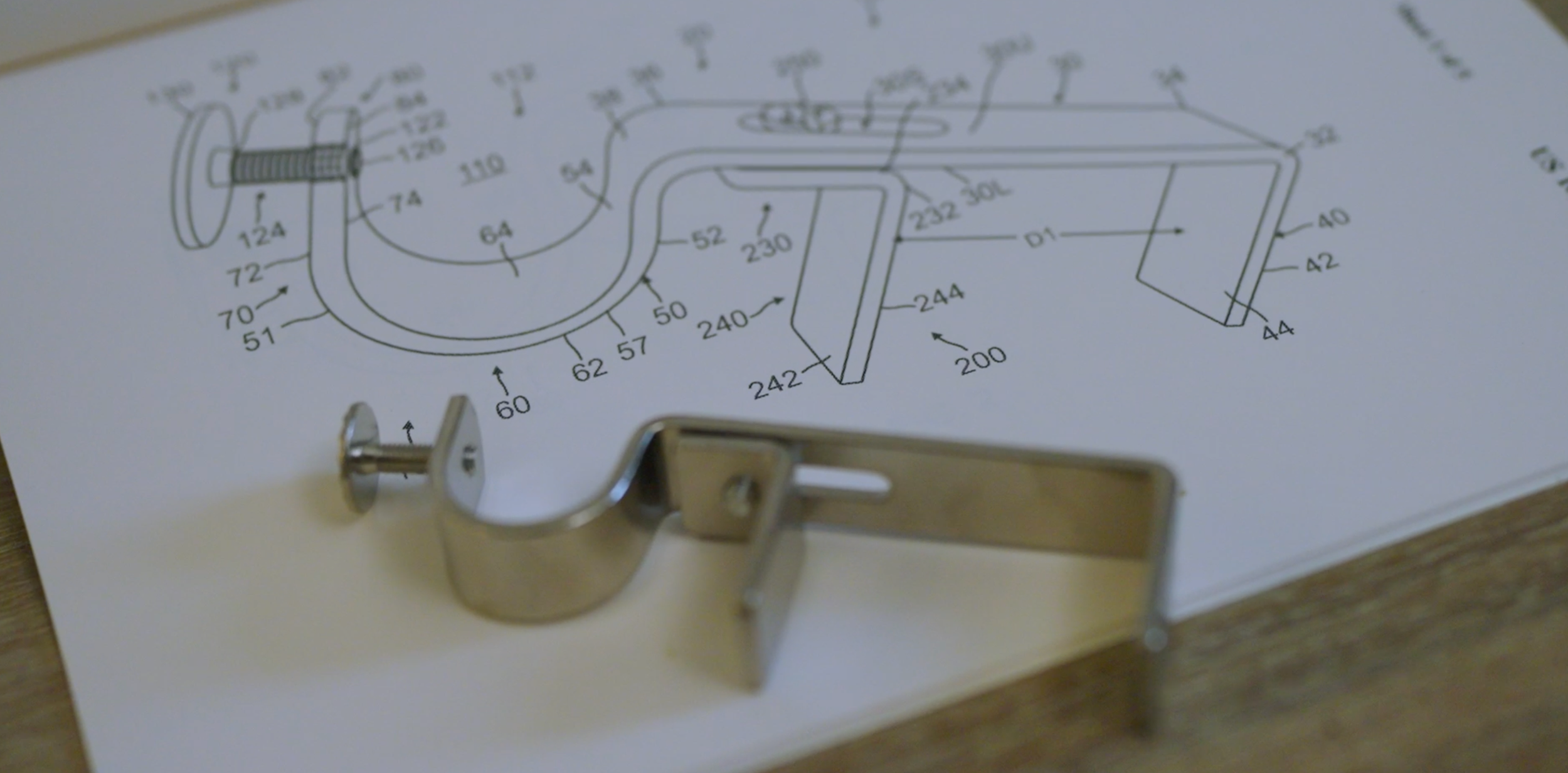Original NoNo Bracket displayed with its patented technical design drawing