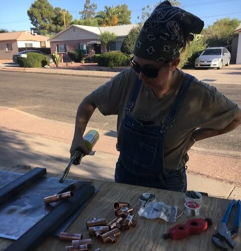 Jessica sweating pipe fittings for our first experimental handwashing stations.