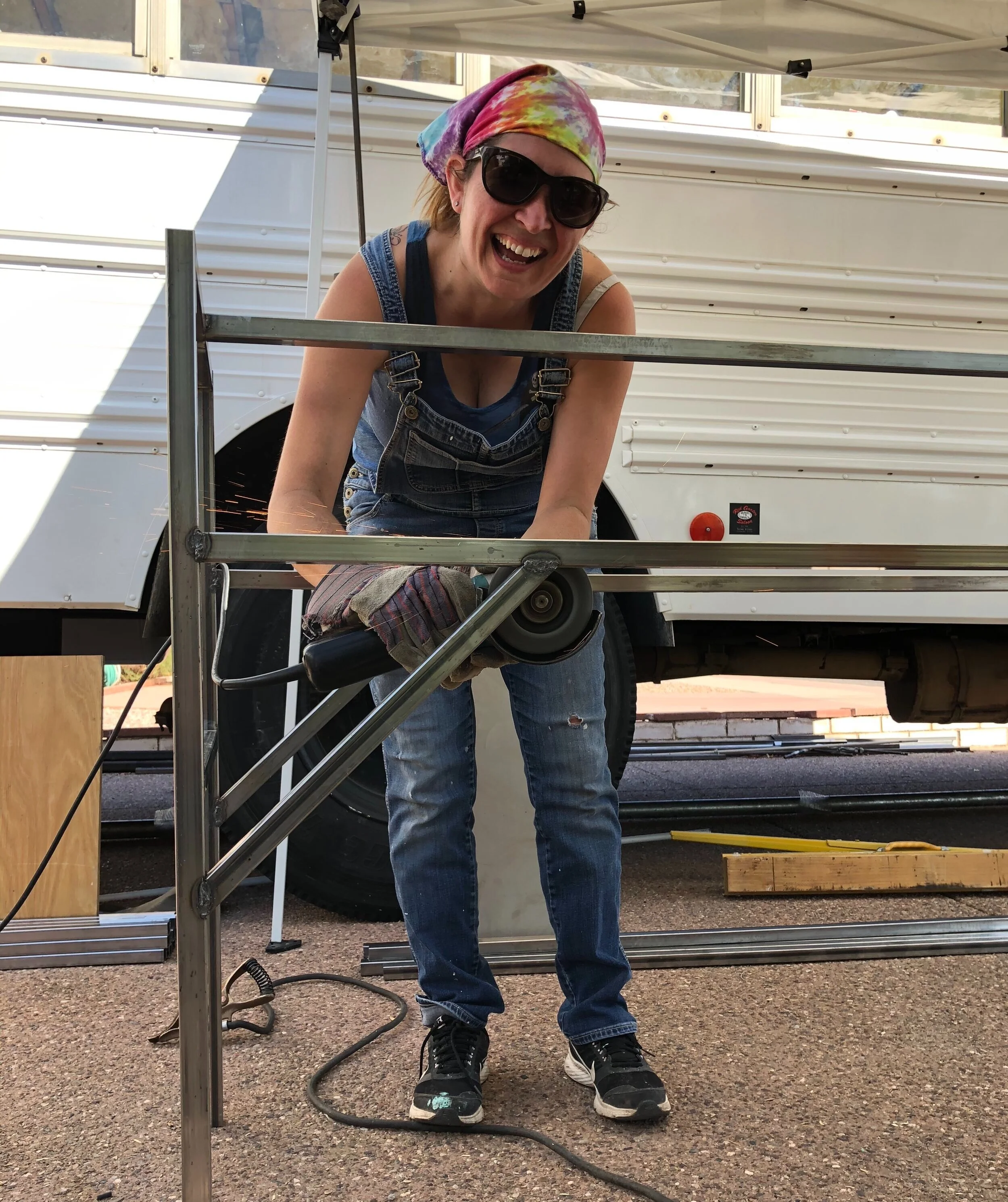 Jessica grinding welds on a handwashing station frame.